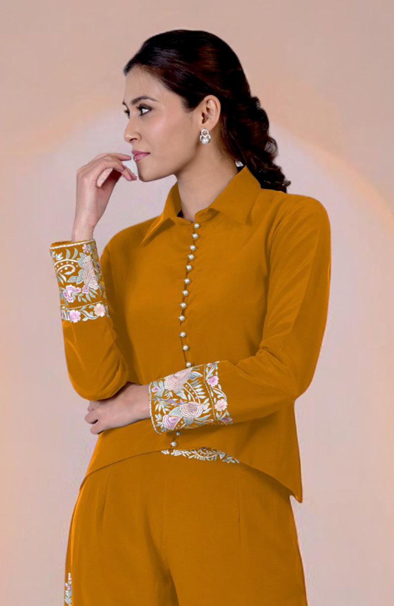 A woman models a yam Parsi Gara embroidered co-ord set with a high-low top.