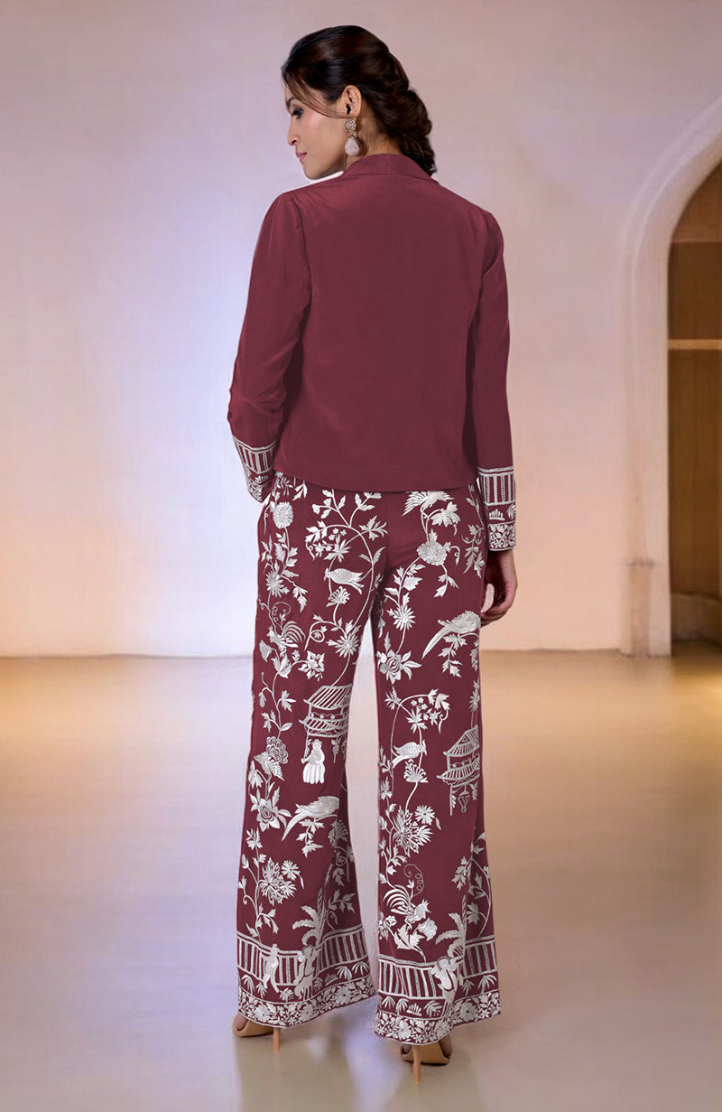 A woman from behind wears a maroon embroidered co-ord set with wide-leg pants.