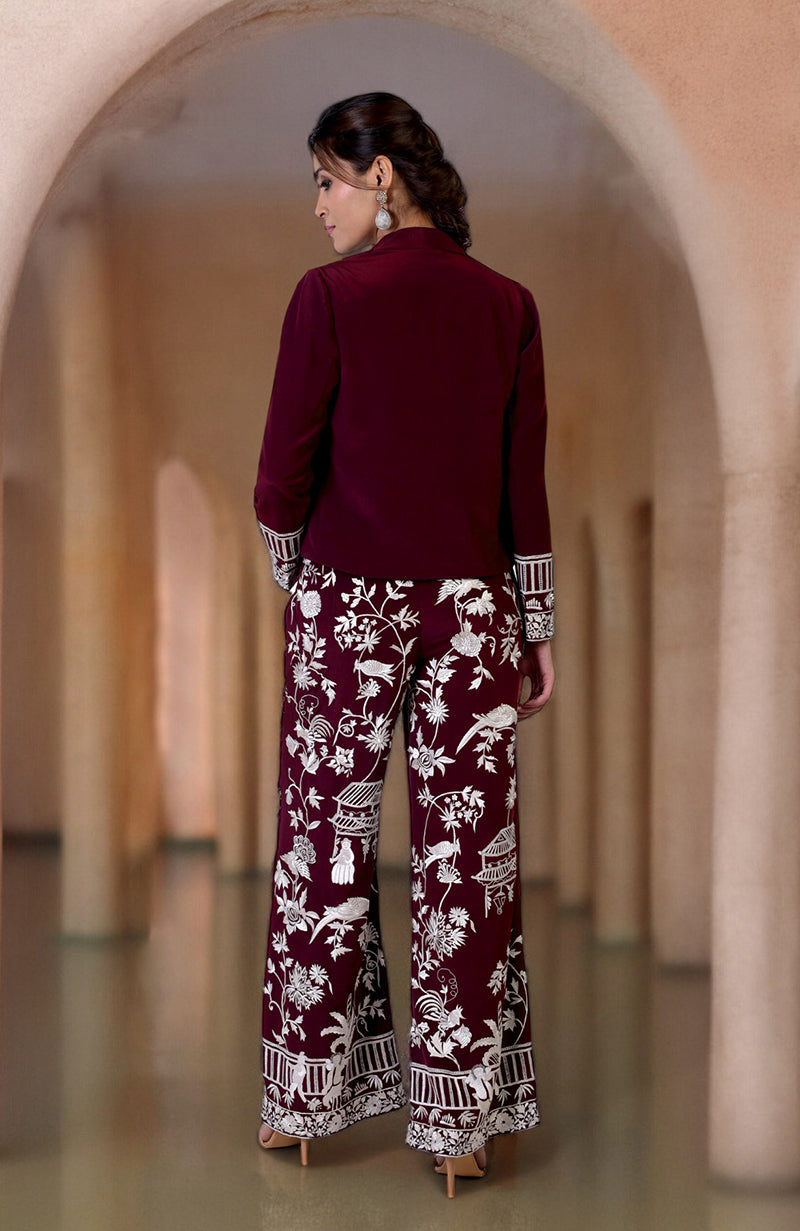 A woman from behind wearing a ruby wine Parsi Gara embroidered co-ord set.
