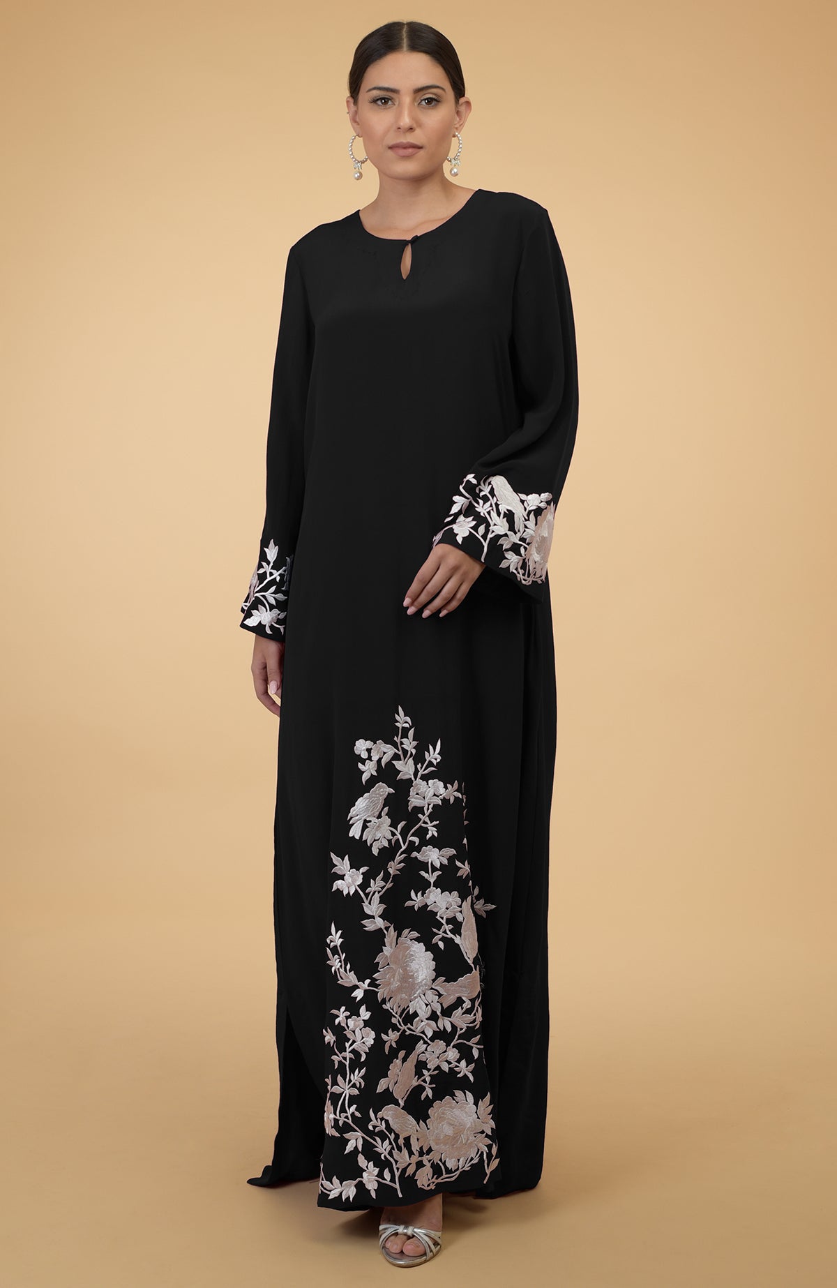 Black silk crepe kaftan with ivory floral and bird embroidery.