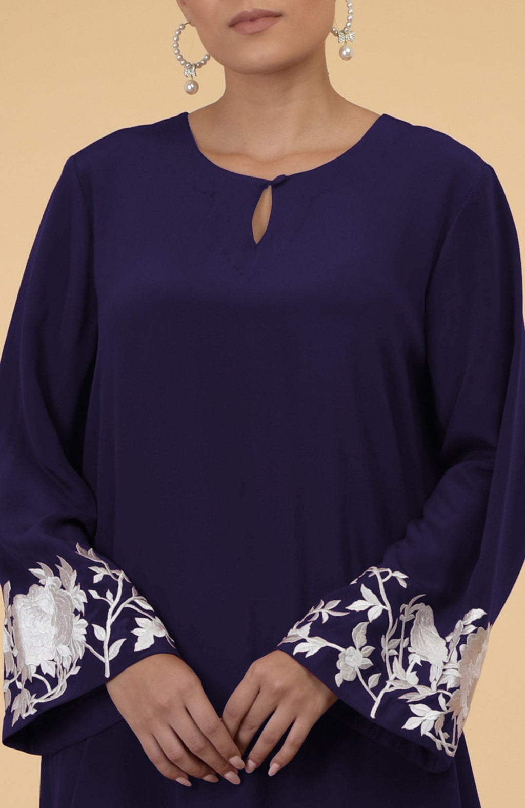 Eclipse blue silk crepe kaftan with floral and bird embroidery on the sleeves.