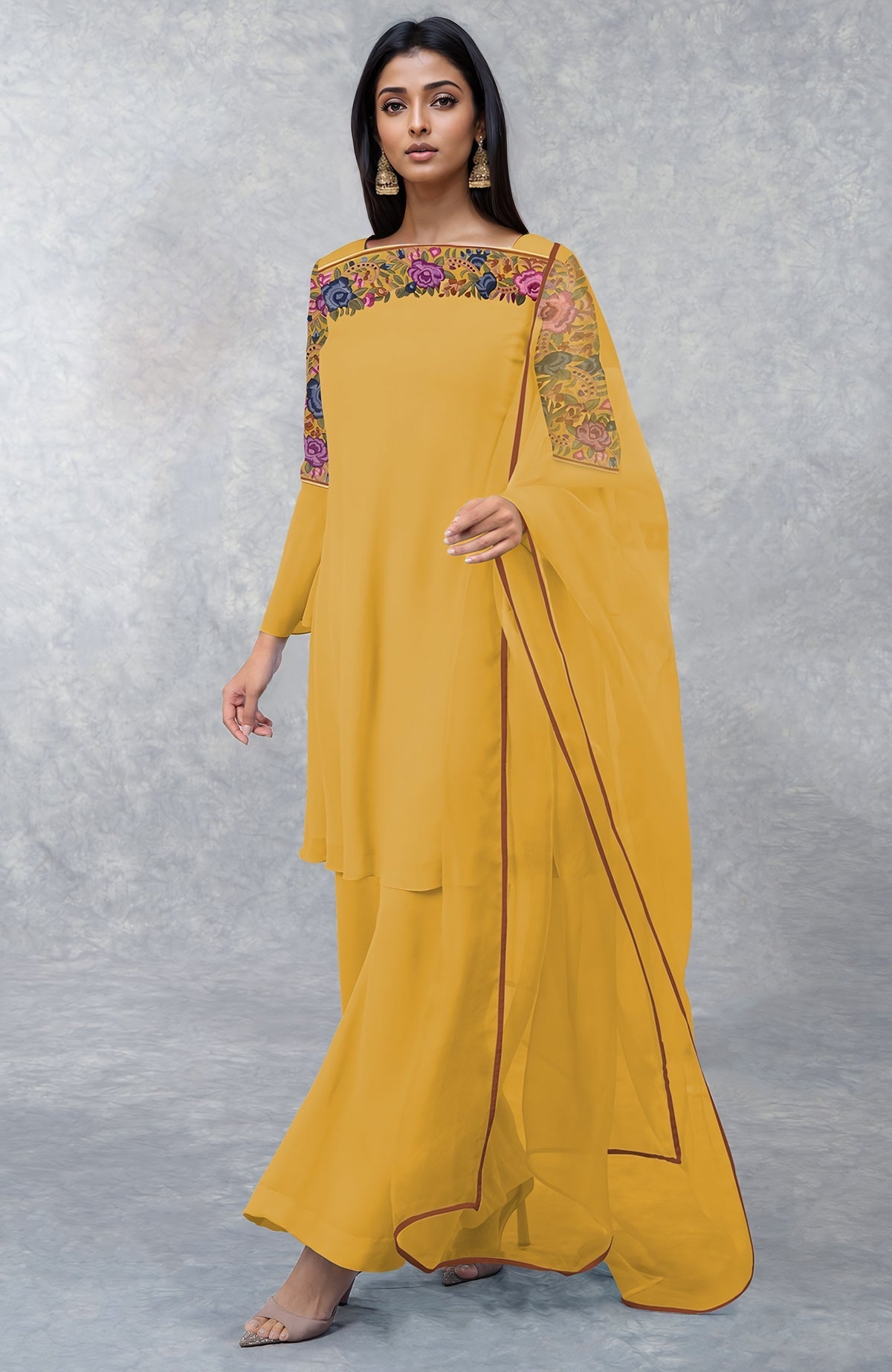 A woman models a calendula yellow Parsi Gara embroidered kurta set.