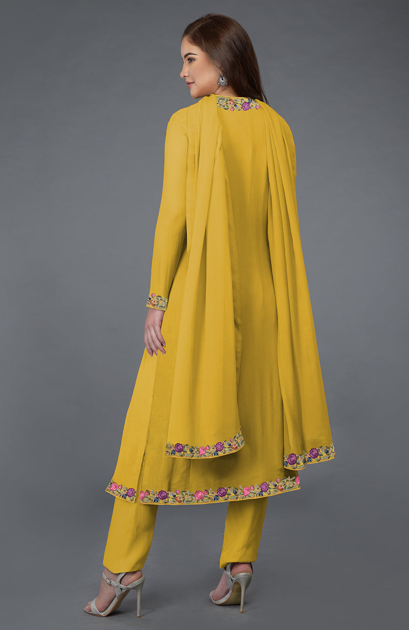 A woman models a calendula yellow Parsi Gara embroidered overlay suit.