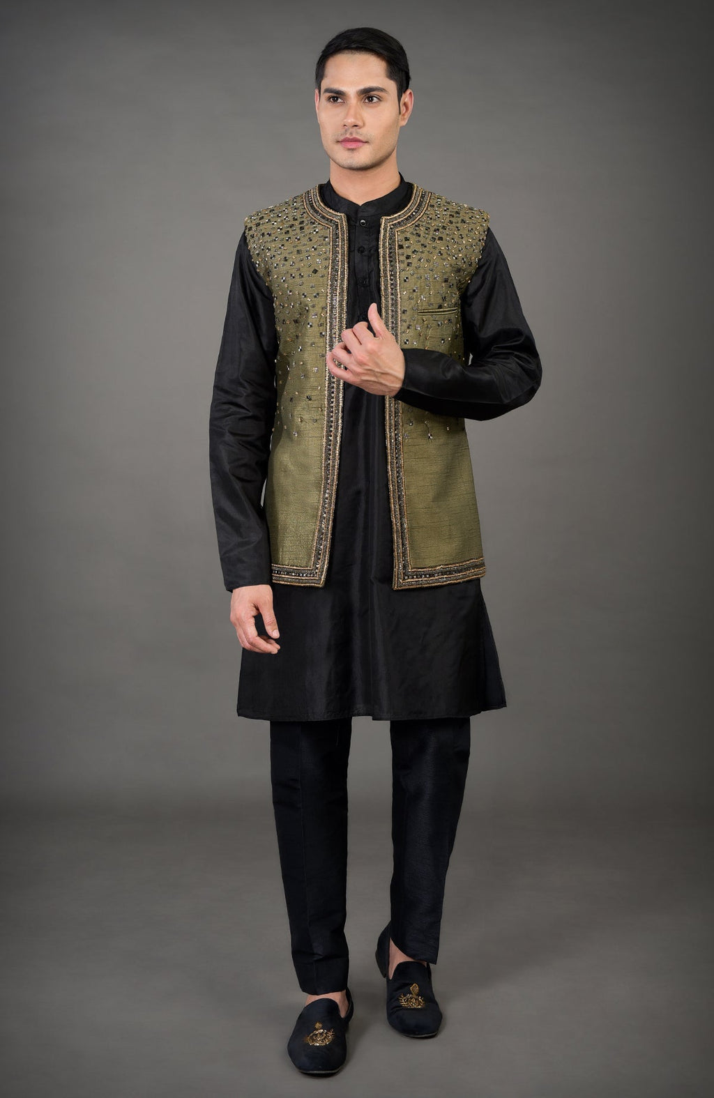 An olive hand-embroidered abstract jacket set with a black kurta and pants.