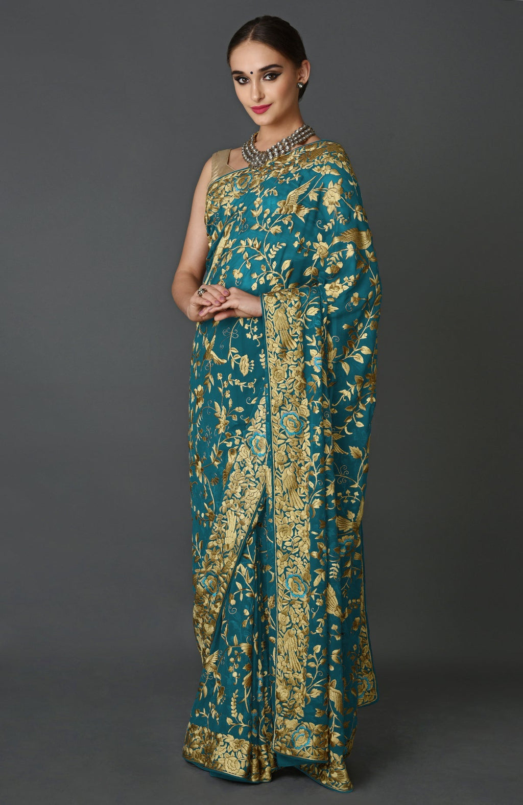 Teal blue georgette saree with beige silk bird and floral Parsi Gara embroidery and matching blouse piece