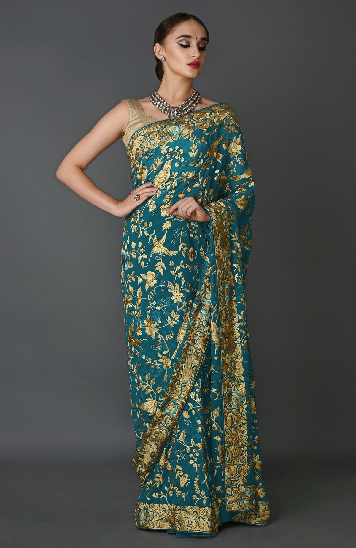 Teal blue georgette saree with beige Parsi Gara bird and floral hand embroidery and matching blouse piece