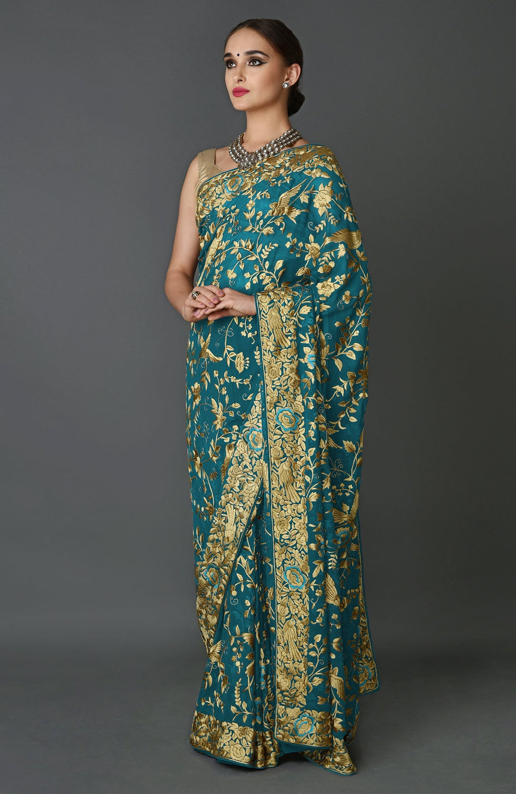 Teal blue georgette saree with beige silk bird and floral hand embroidery and matching blouse piece