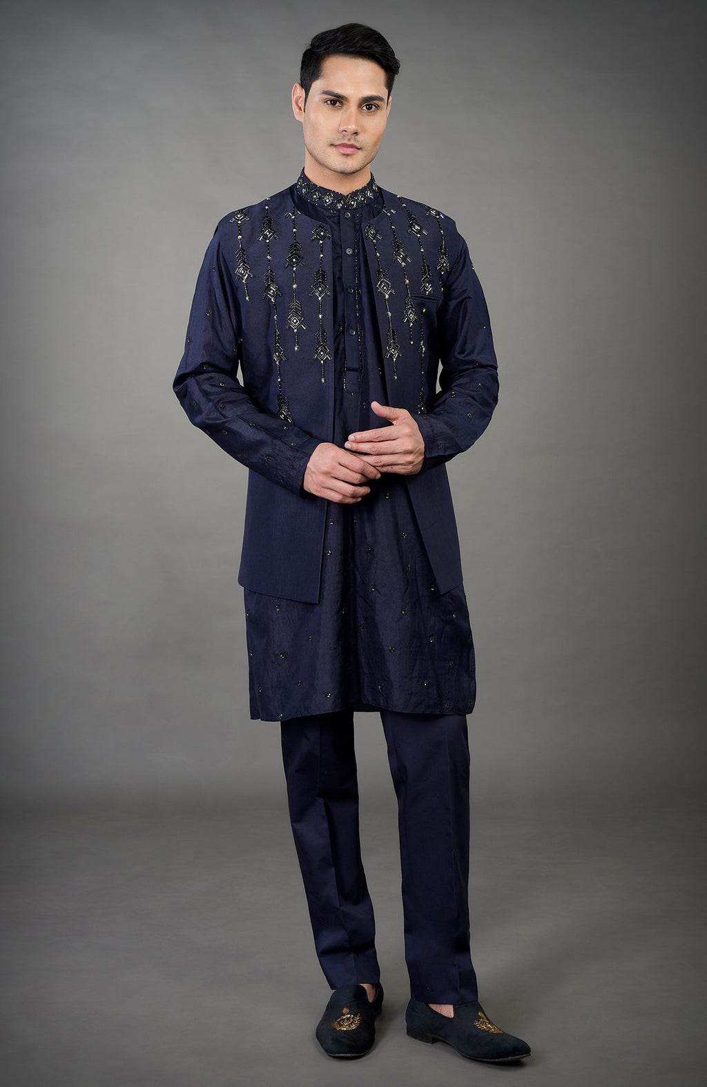 Blue geometric hand embroidered jacket set with matching kurta and pants.