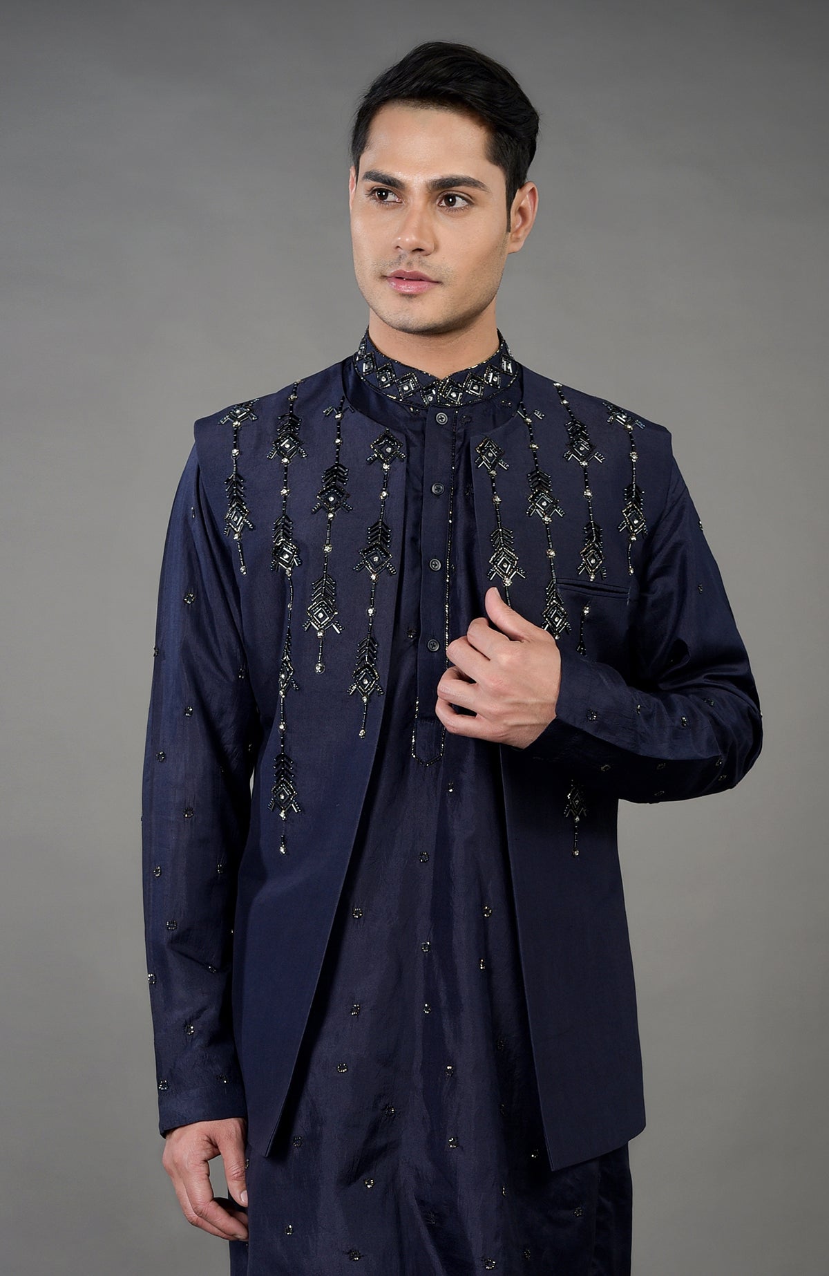Blue geometric hand embroidered jacket set on a man.