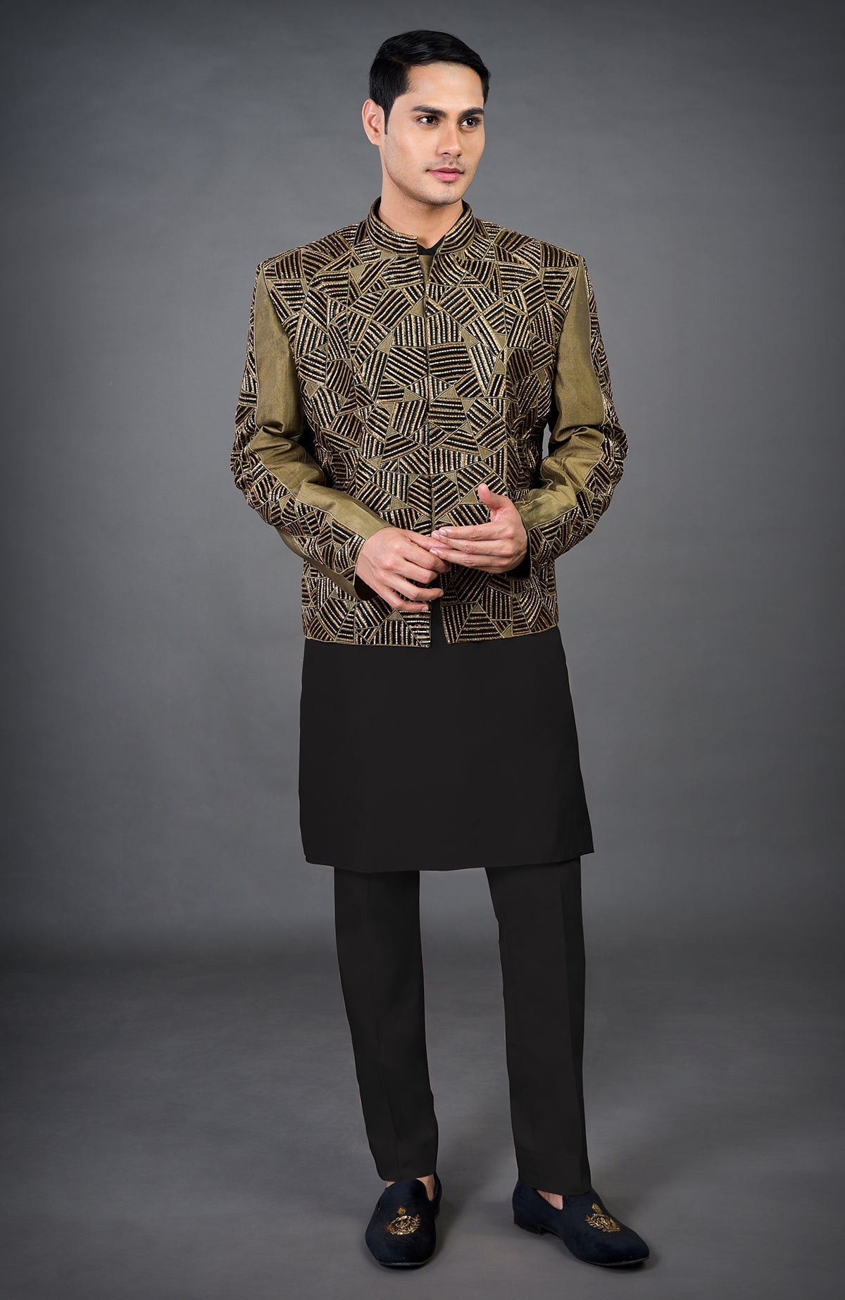 An olive hand-embroidered jacket set with a black kurta and pants.