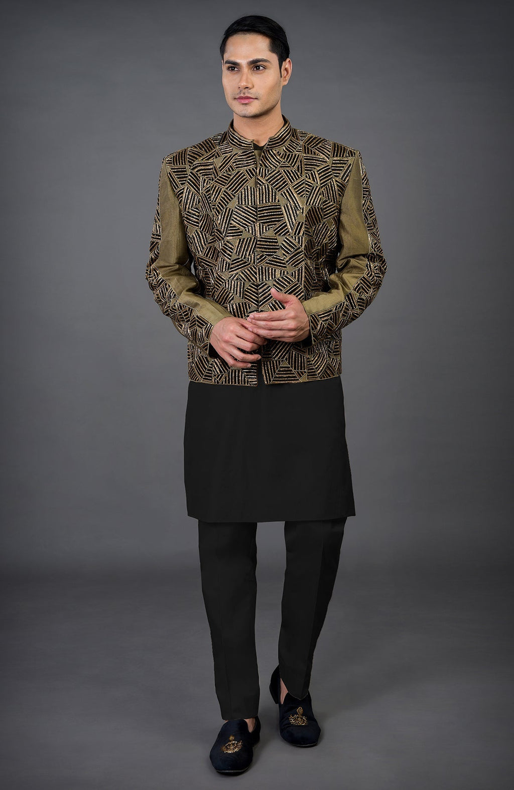 An olive hand-embroidered jacket set with a black kurta and pants.