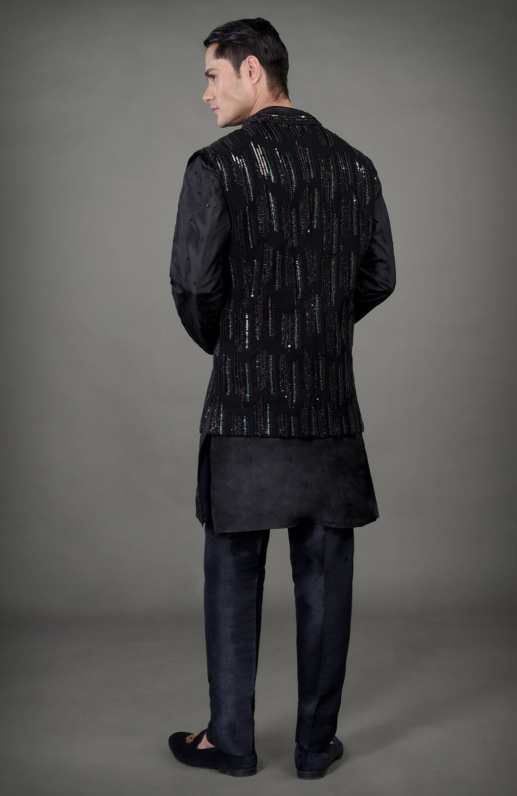 Black hand-embroidered jacket set with a kurta and trousers.