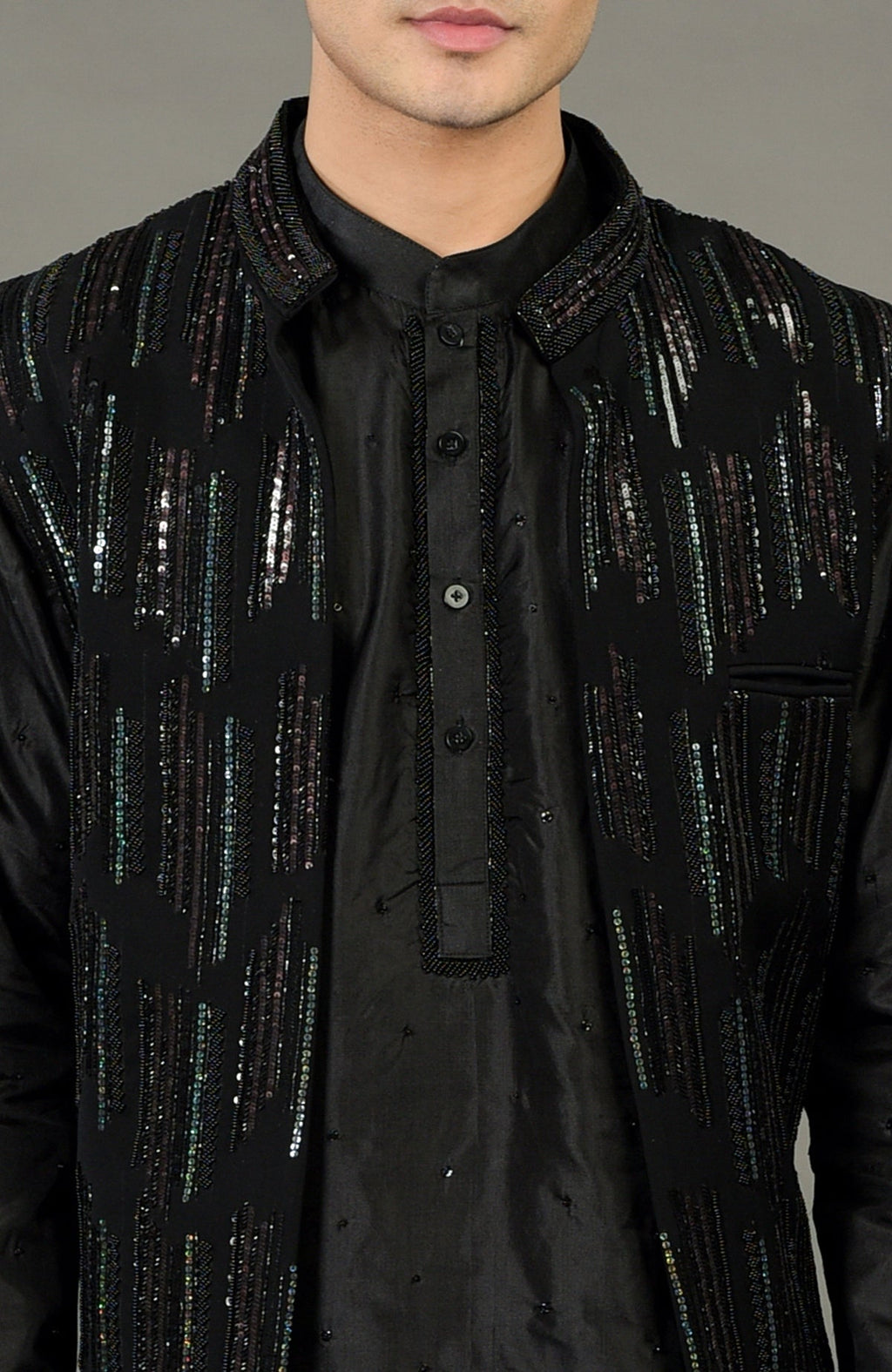 Black hand-embroidered jacket set with a black kurta and intricate beadwork.