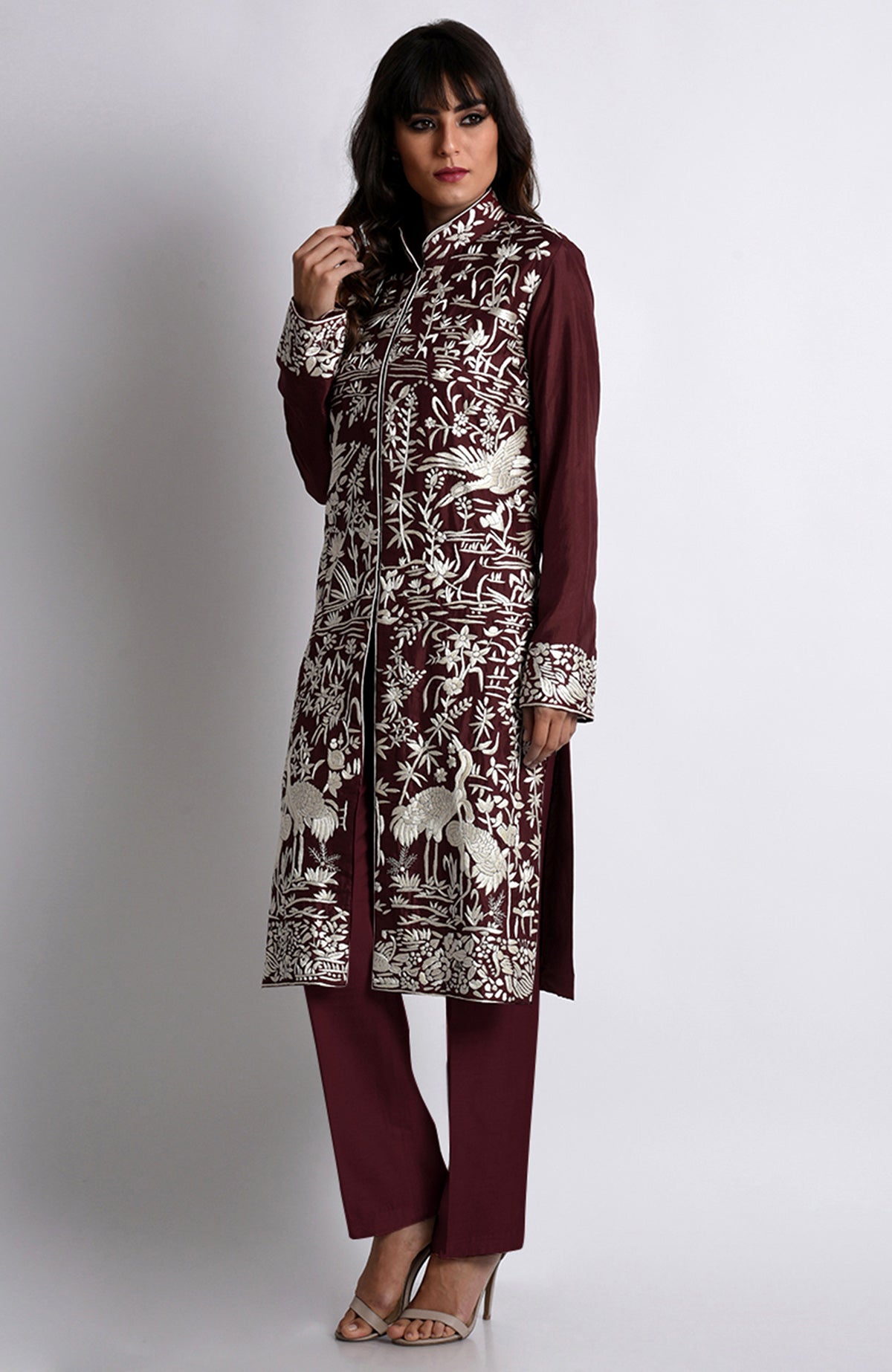 Maroon Parsi Gara embroidered jacket set with ivory floral and crane-bird patterns.
