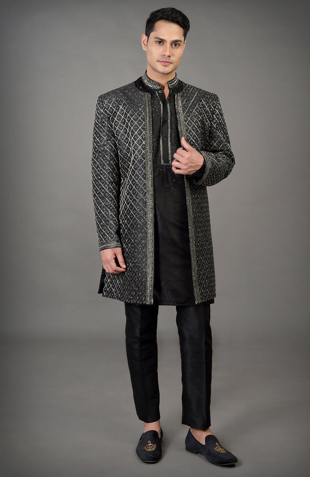 Black hand-embroidered jacket set with a kurta and pants.