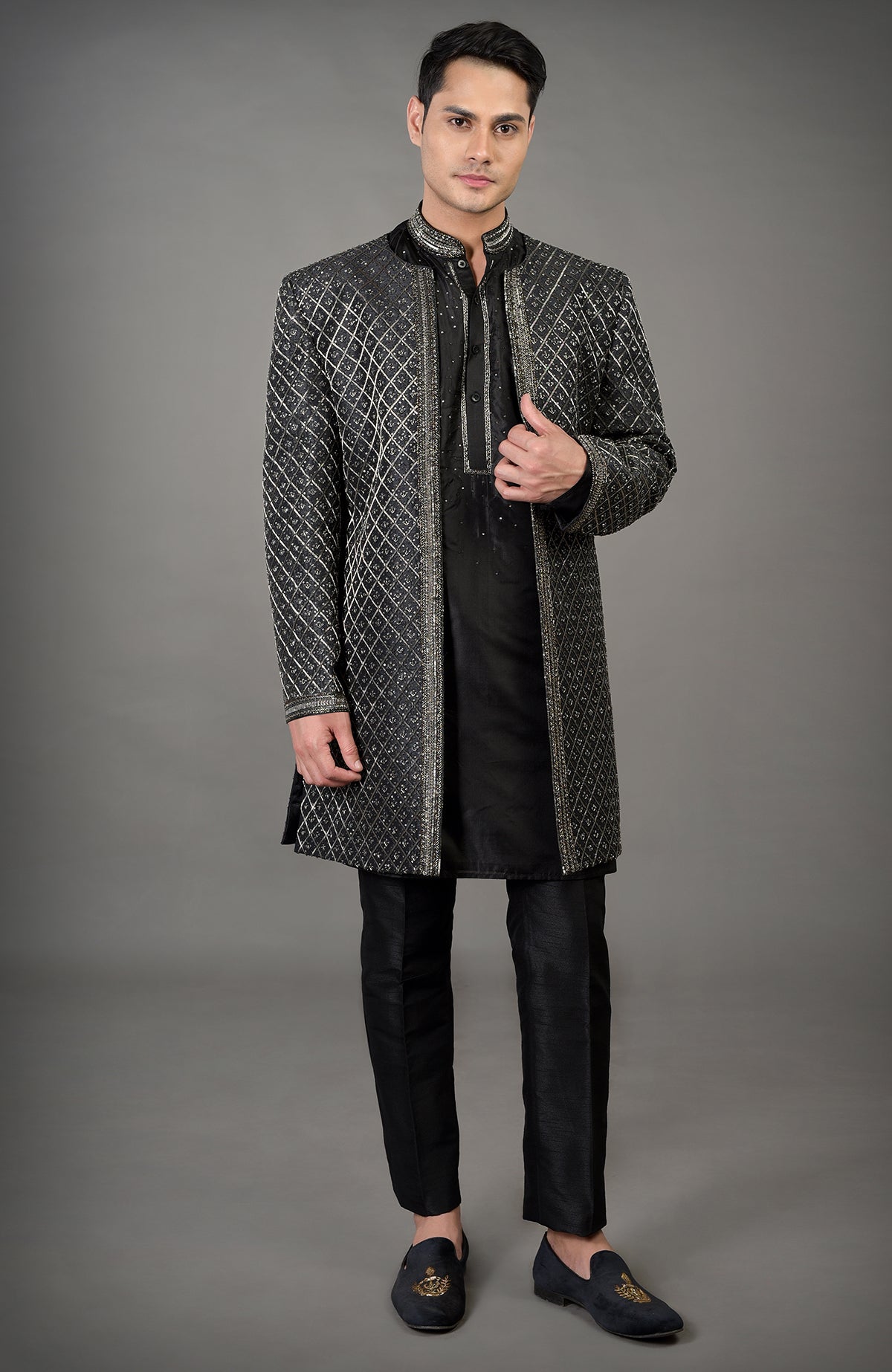 Black hand-embroidered jacket set with a kurta and pants.