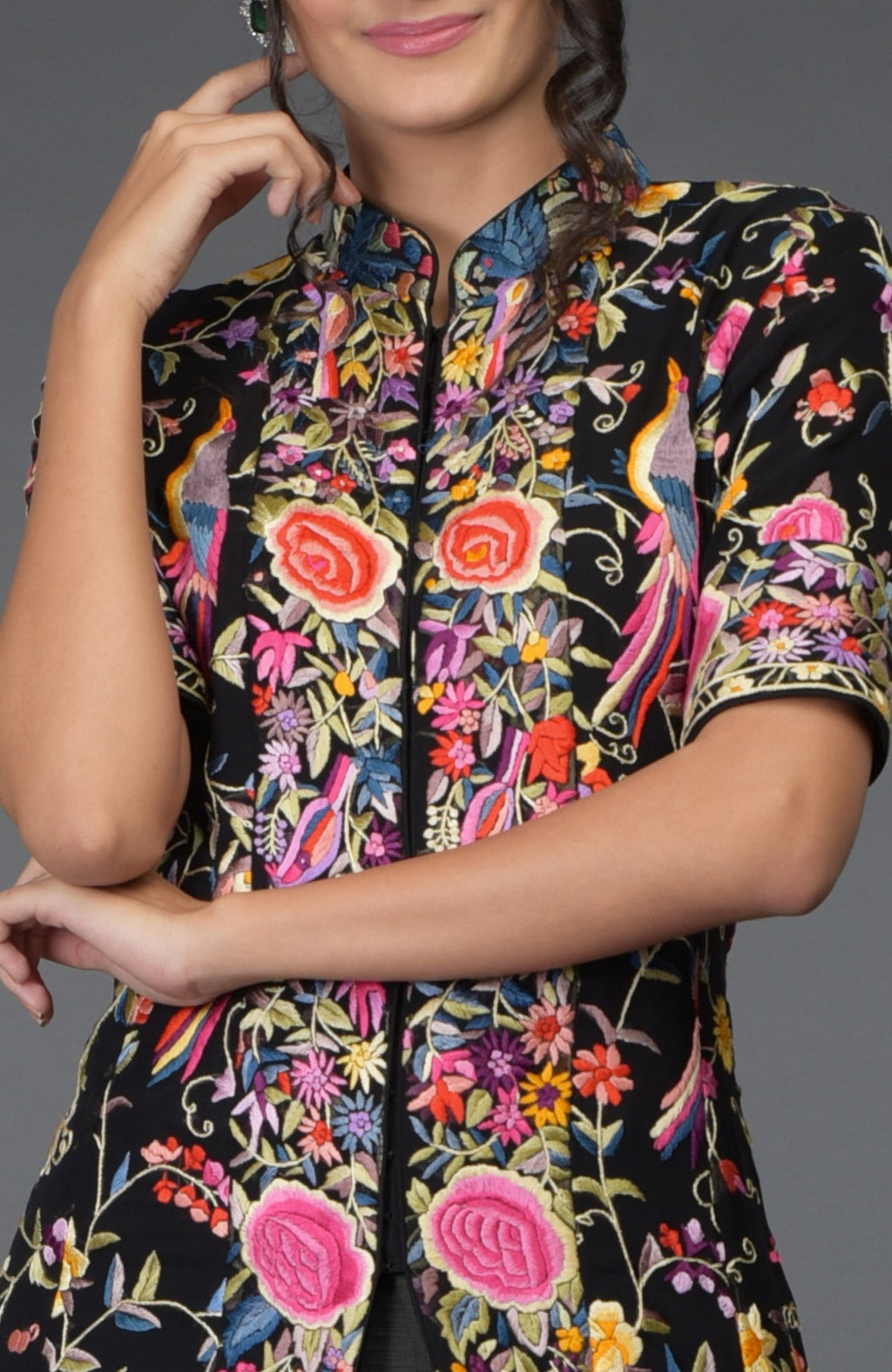 Black flared jacket with colorful Parsi Gara embroidery paired with a grey skirt.