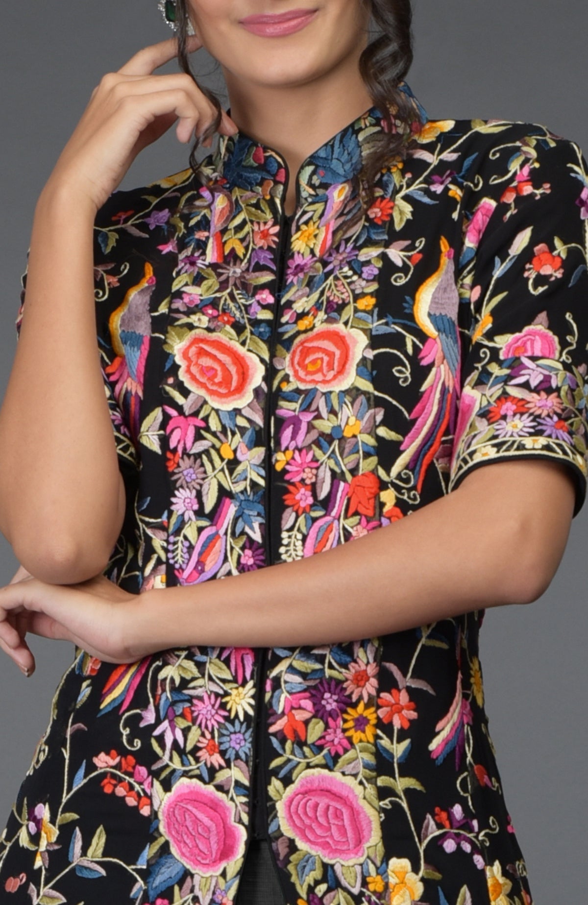 Black flared jacket with colorful Parsi Gara embroidery paired with a grey skirt.