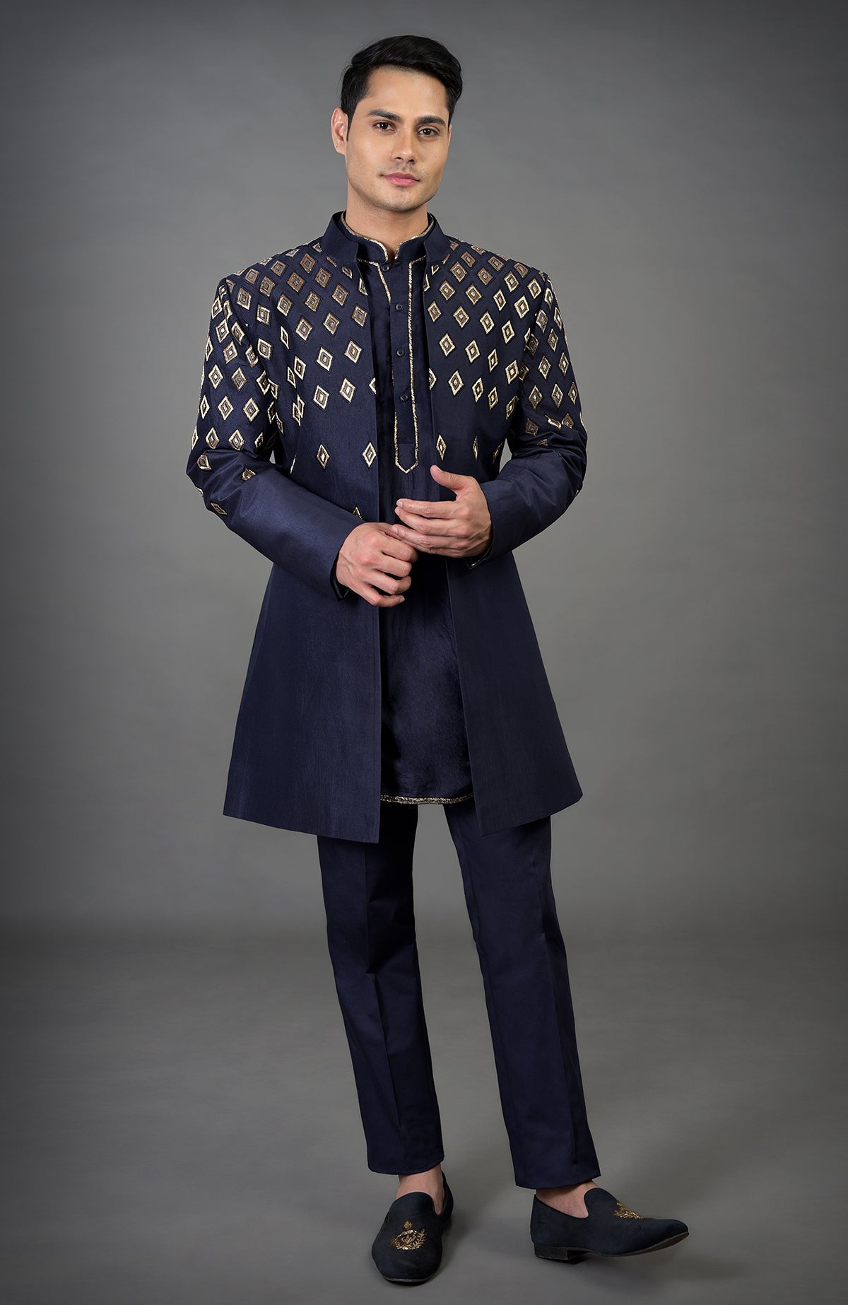 Blue diamond hand embroidered jacket set with matching kurta and pants.