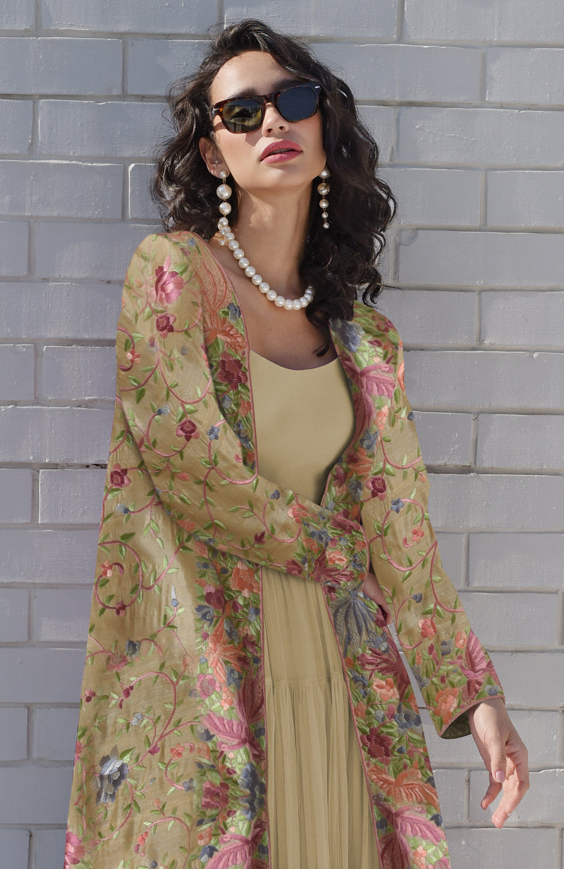 Beige Parsi Gara embroidered jacket set with a light beige pleated dress.