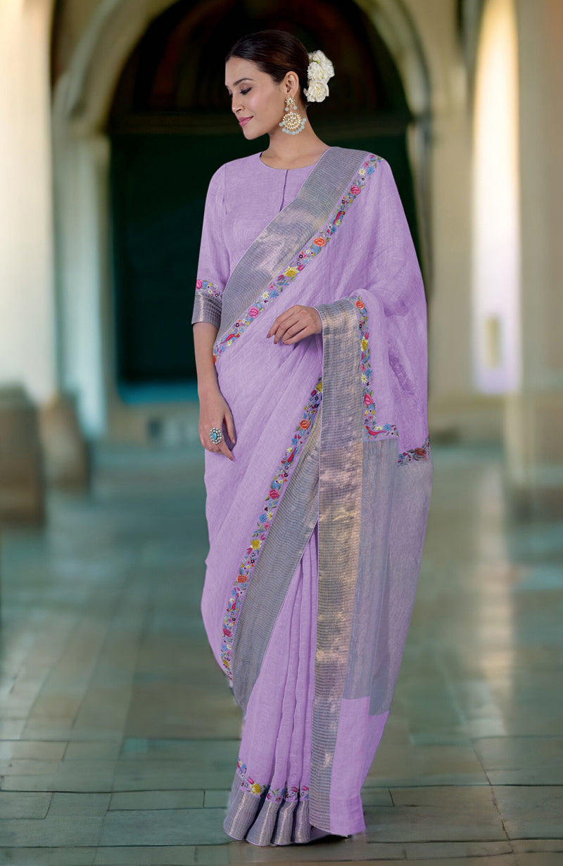 A woman models a lavender linen saree with Parsi Gara embroidery and zari borders.