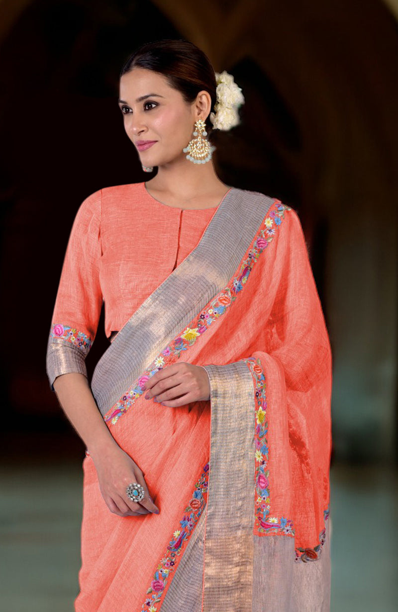 Living coral linen saree with Parsi Gara embroidery and zari details.