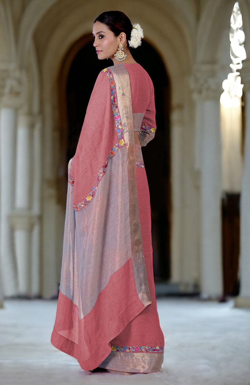 A woman models a desert rose and grey linen saree with Parsi Gara embroidery.