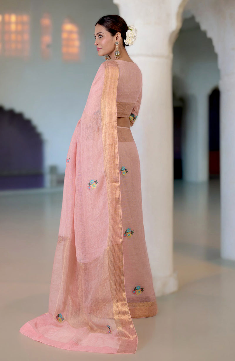 Pink linen saree with Kashidakari embroidery and gold zari border.