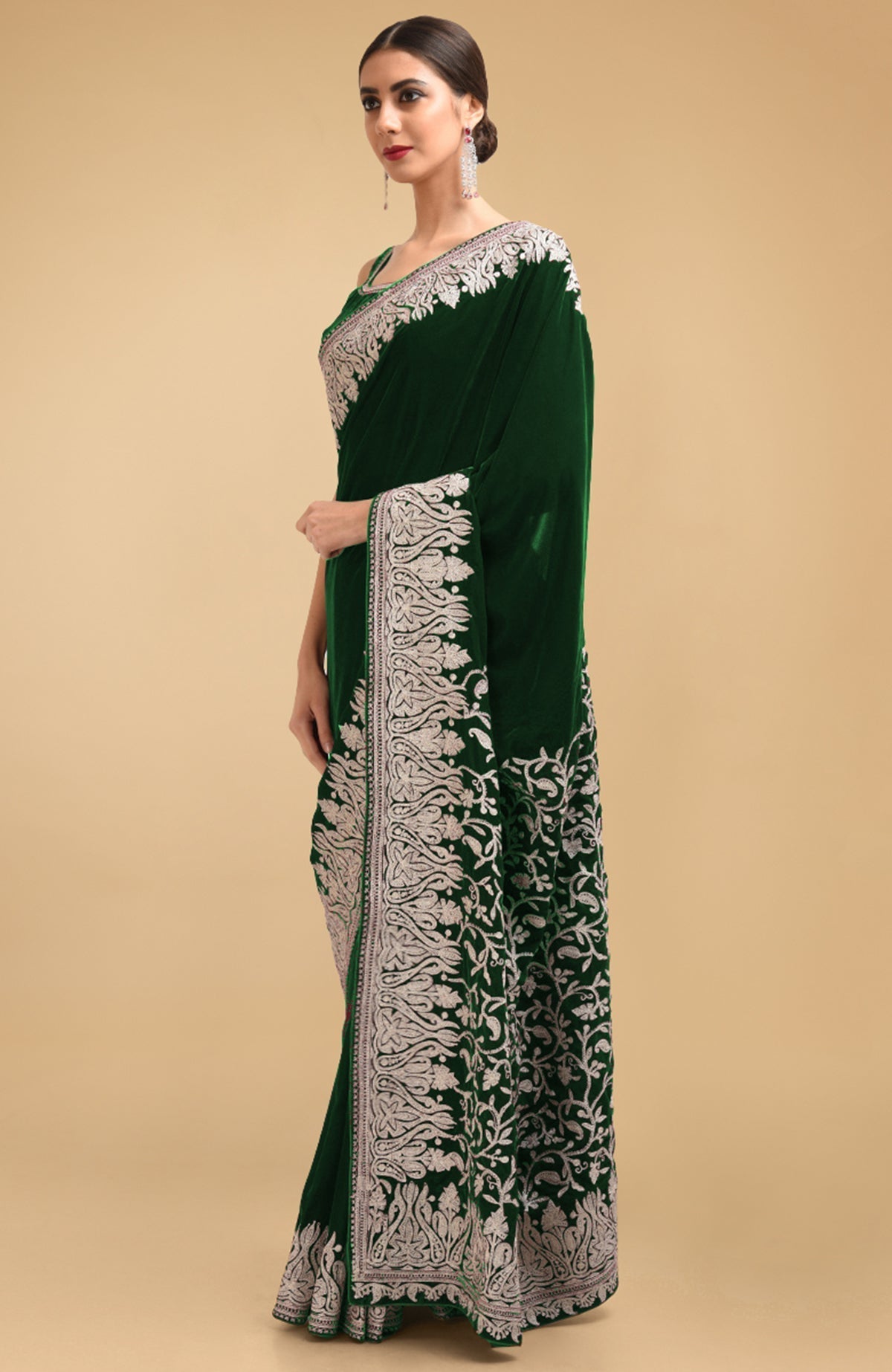 Bottle green velvet saree with silver Kashmiri tilla aari embroidery on borders and pallav.