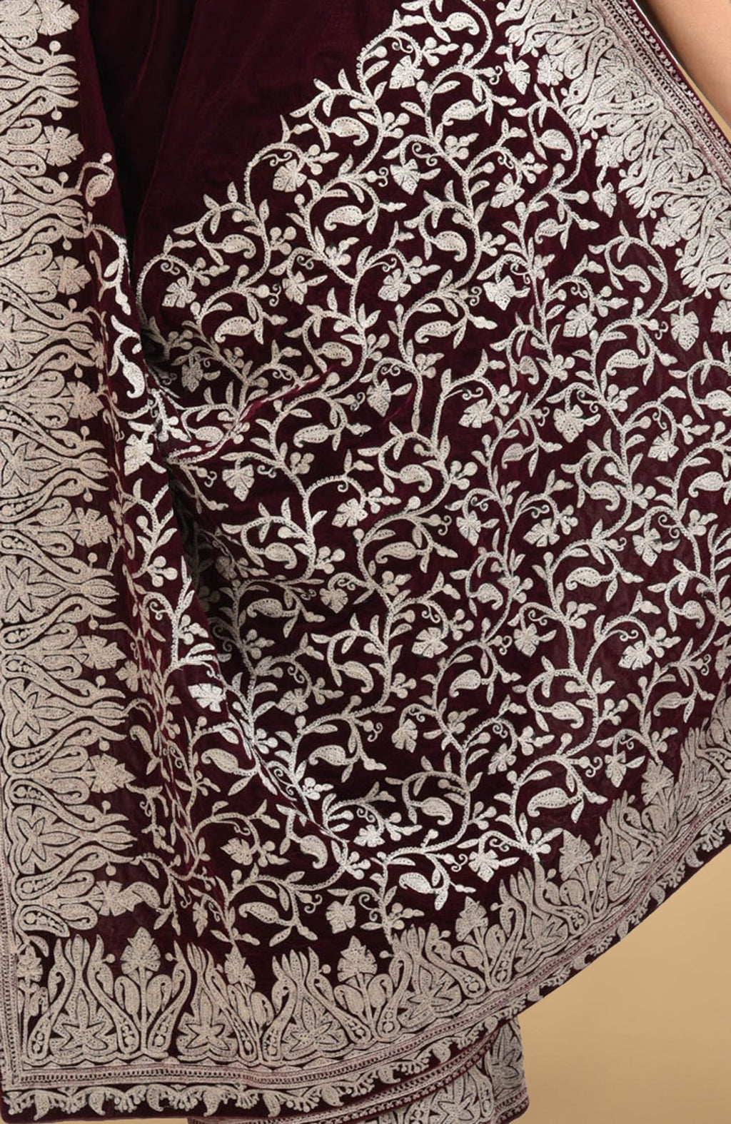 Plum velvet saree with intricate silver tilla aari embroidery on the pallav and borders.