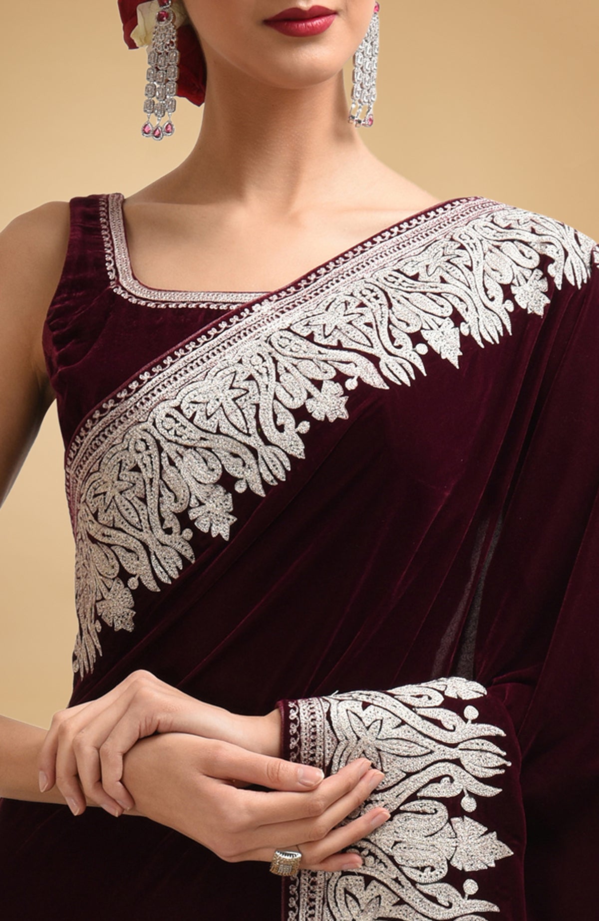 Plum velvet saree with silver tilla aari embroidery, paired with a matching blouse.