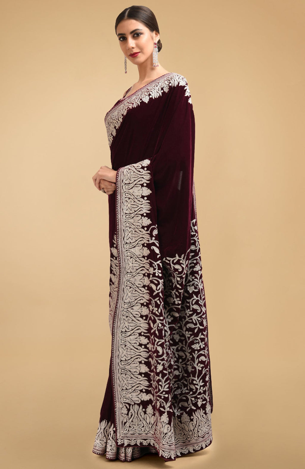 Plum velvet saree with silver tilla aari embroidery on the pallav and borders.