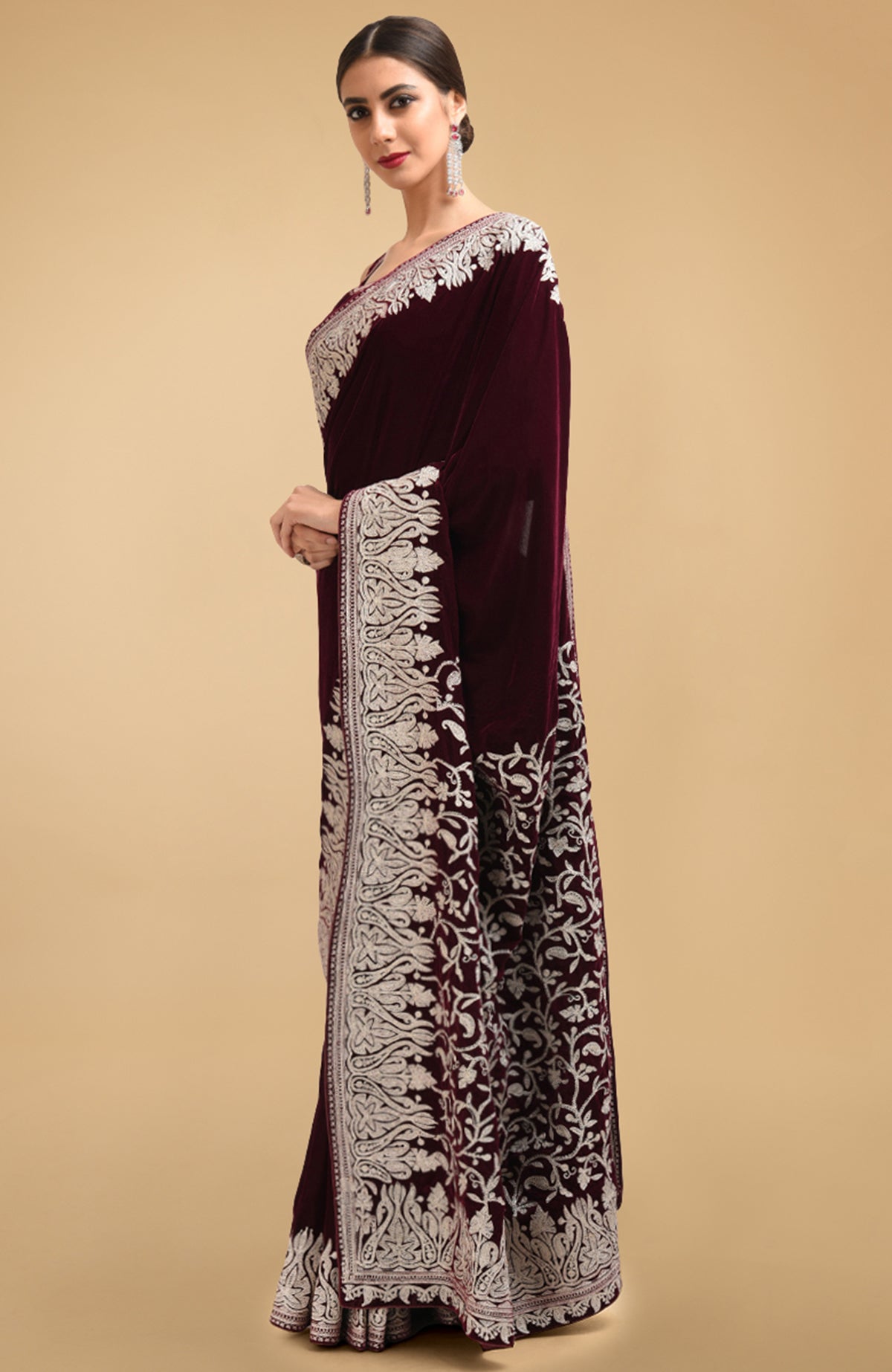 Plum velvet saree with silver tilla aari embroidery on the pallav and borders.