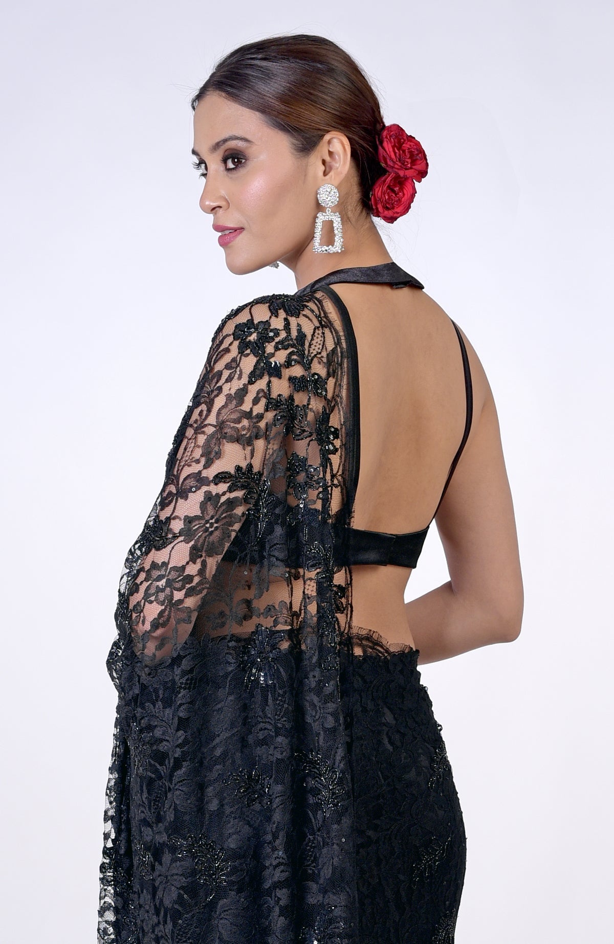 Black French Chantilly lace saree with hand embroidery, worn by a woman from behind.