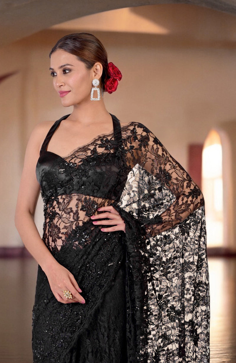 Black French Chantilly lace saree with hand embroidery, worn by a woman.