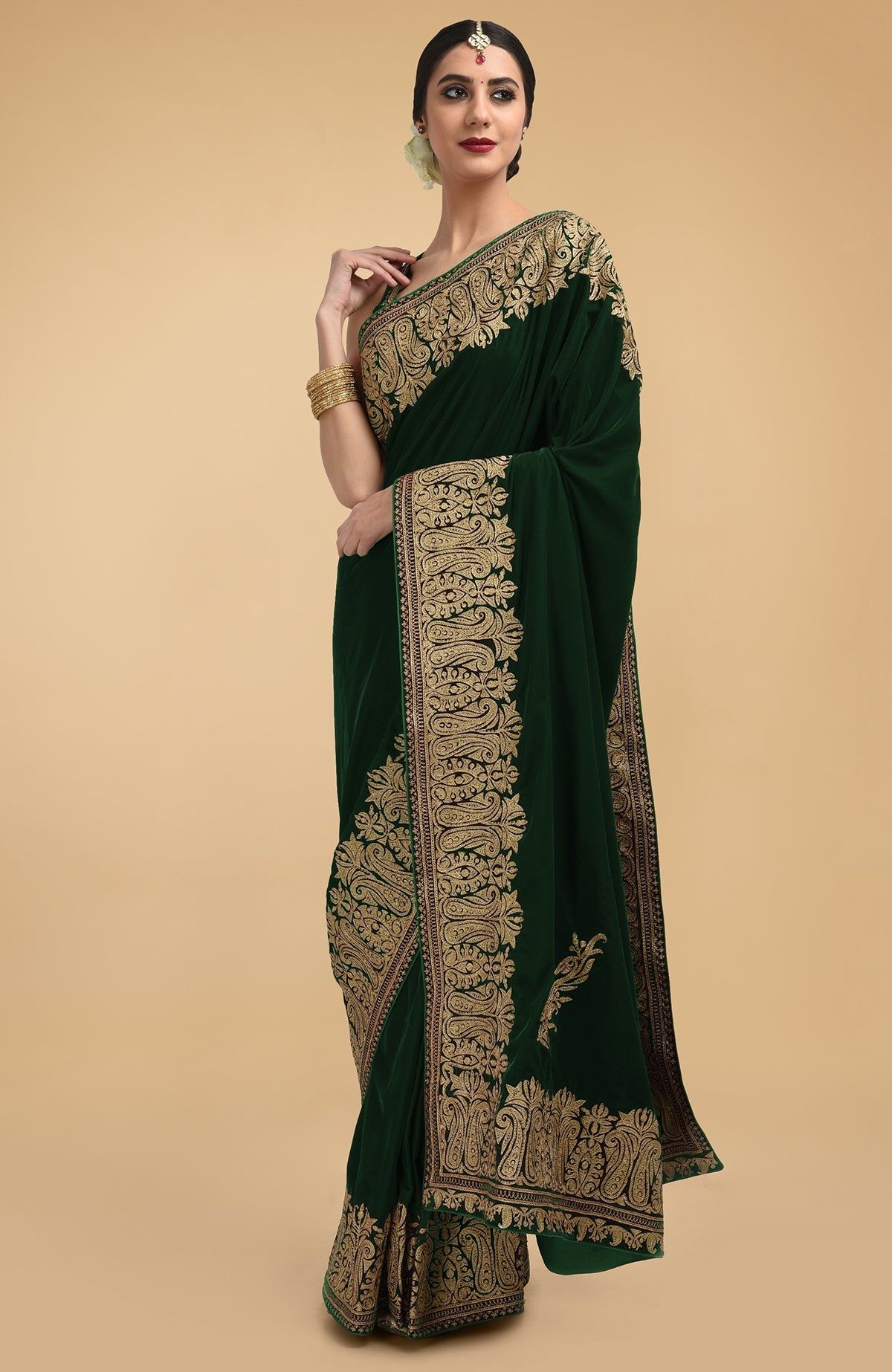 Bottle green velvet saree with gold Kashmiri tilla aari embroidery on borders and pallav.