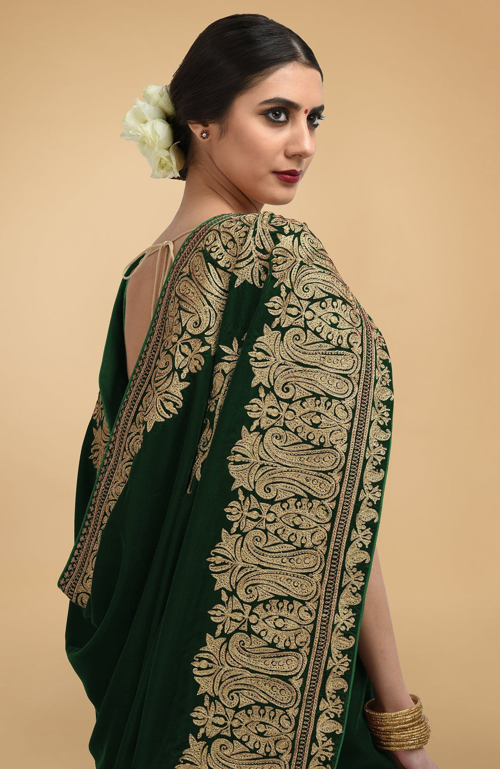 Bottle green velvet saree with gold Kashmiri tilla aari embroidery on borders and pallav.