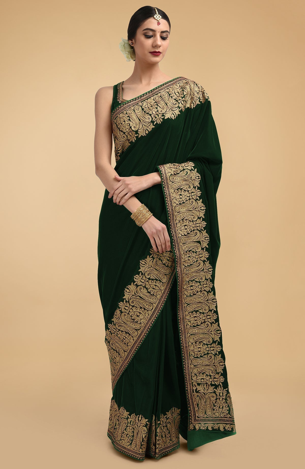 Bottle green velvet saree with gold Kashmiri tilla aari embroidery on borders and pallav.