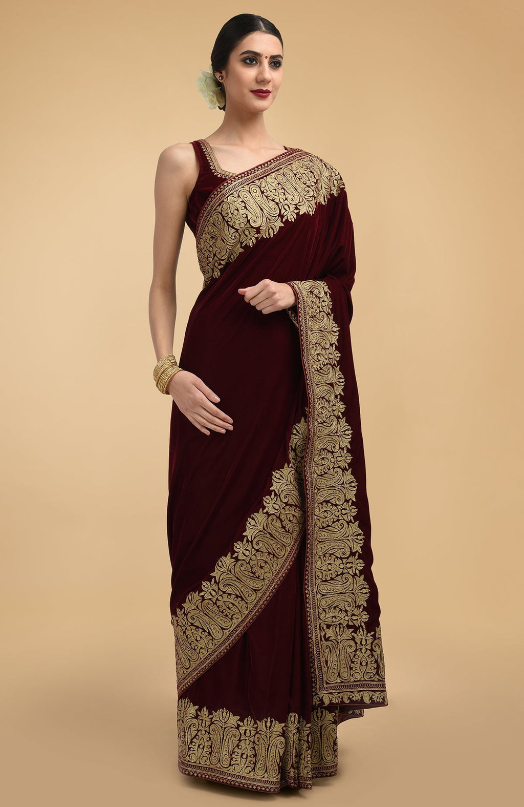 Burgundy velvet saree with gold tilla aari embroidery and a matching blouse.