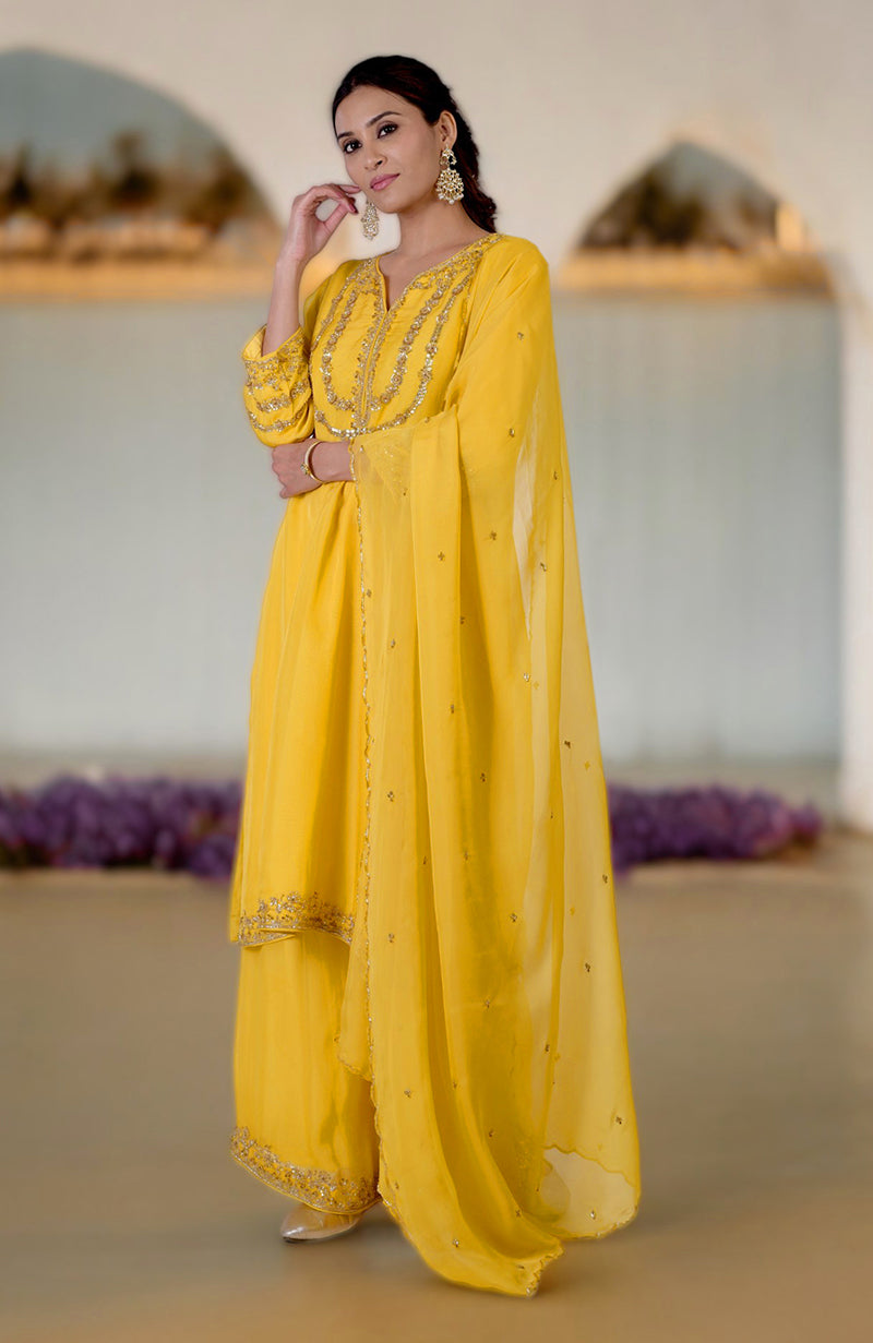 Buttercup yellow zardozi hand-embroidered suit set with a matching dupatta.