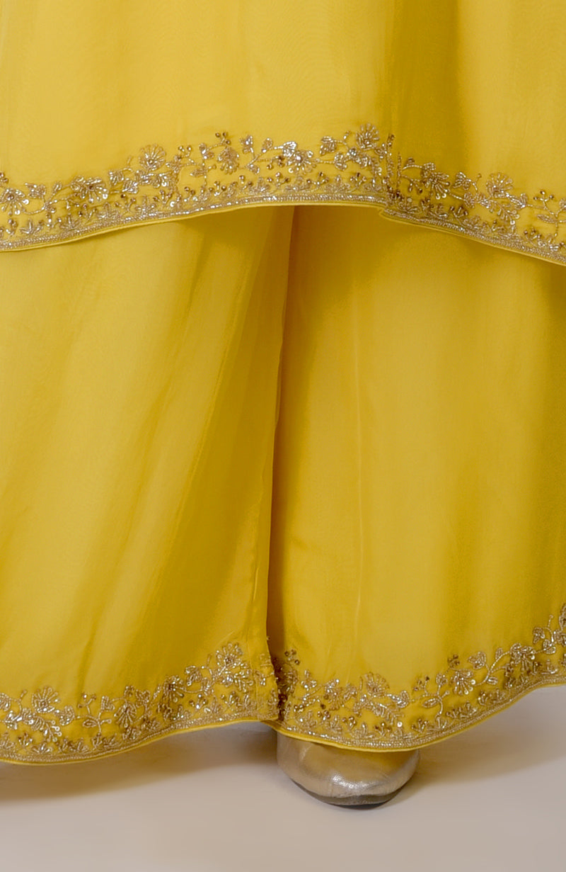 Buttercup yellow suit set with intricate gold zardozi and sequin embroidery.