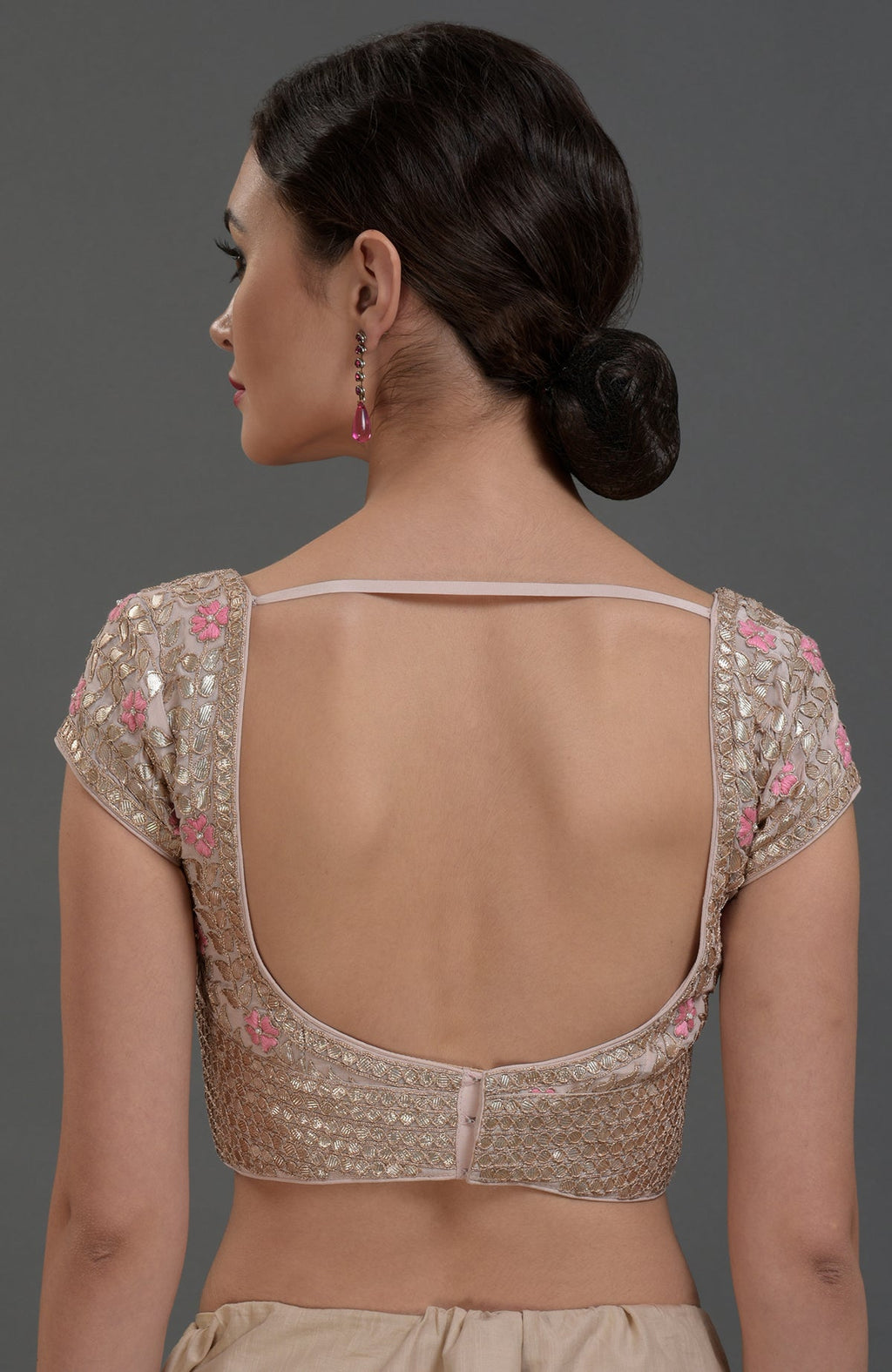 Nude pink blouse with gold gota patti and pink floral embroidery, open back.