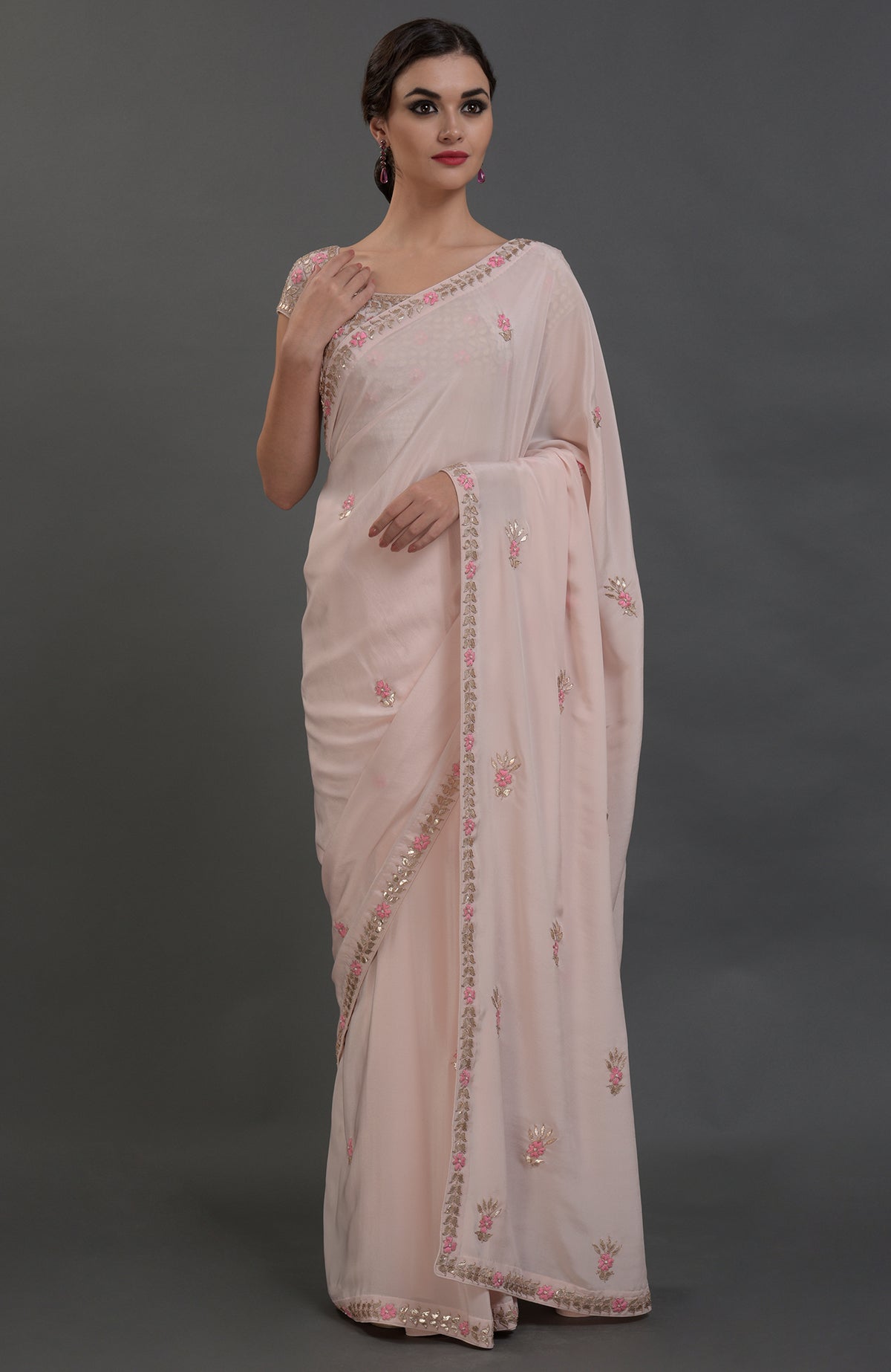 Nude pink pure crepe saree with rose gold gota patti and floral hand embroidery.