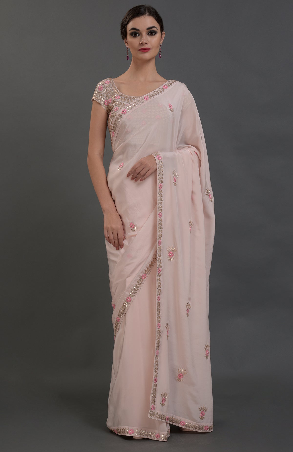 Nude pink pure crepe saree with rose gold gota patti and floral hand embroidery.