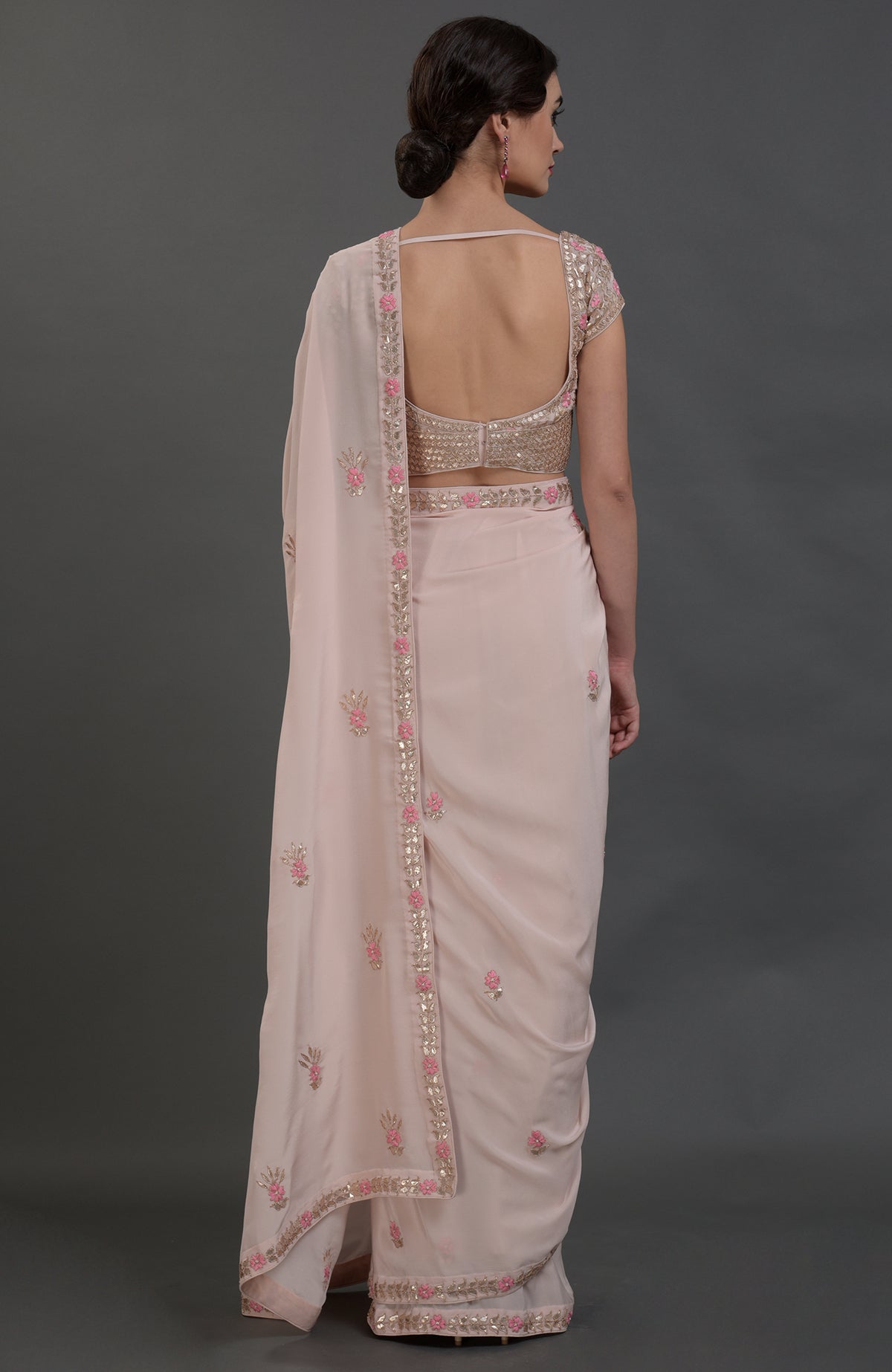 Nude pink pure crepe saree with rose gold gota patti and floral hand embroidery.