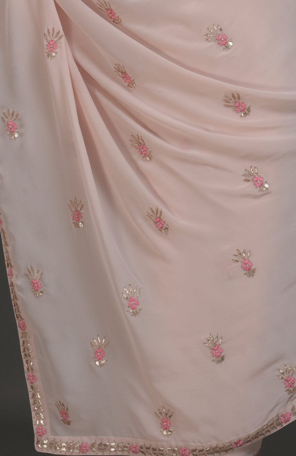 Nude pink pure crepe saree with rose gold gota patti and floral hand embroidery.