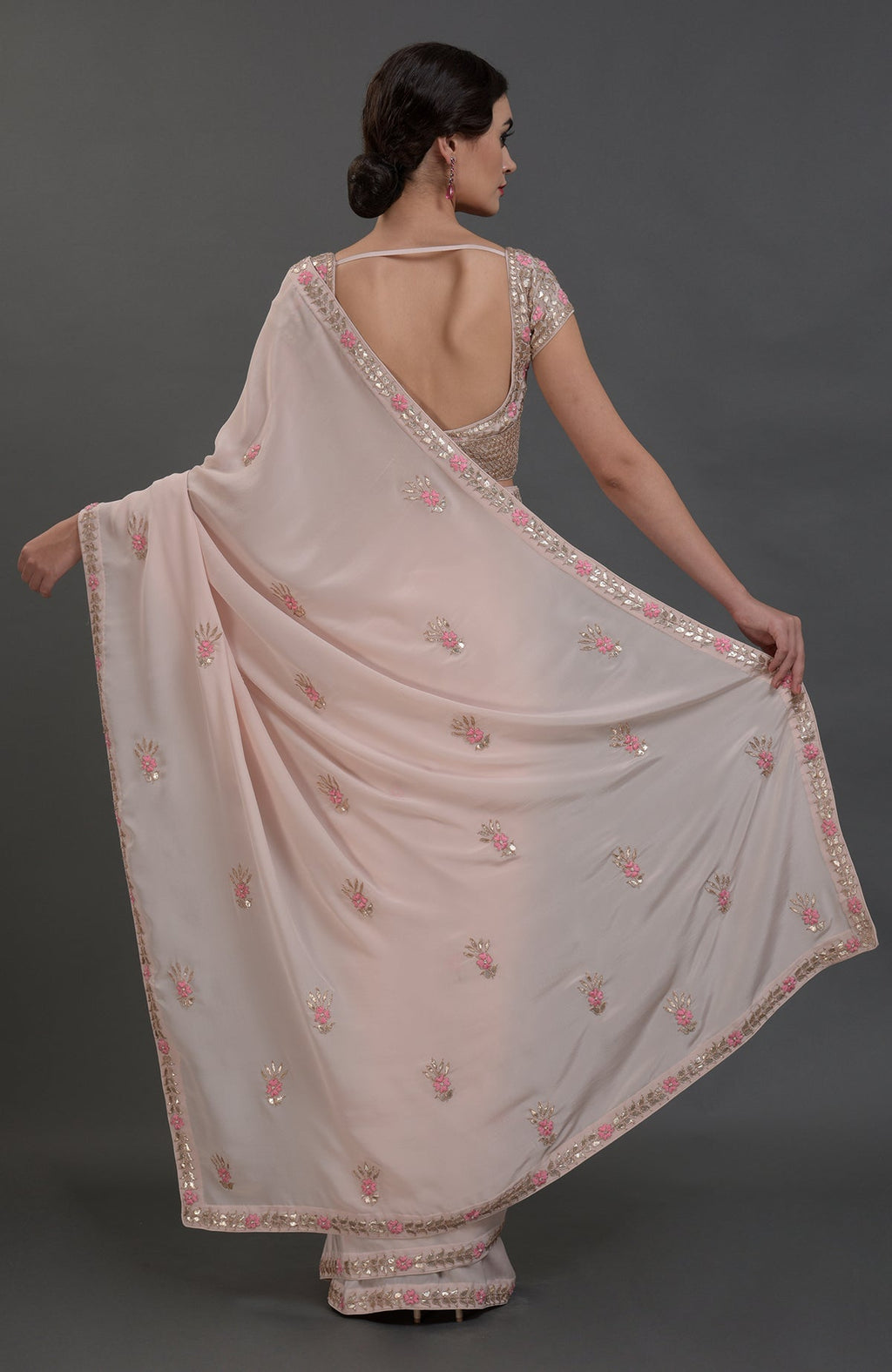 Nude pink pure crepe saree with rose gold gota patti and floral hand embroidery.