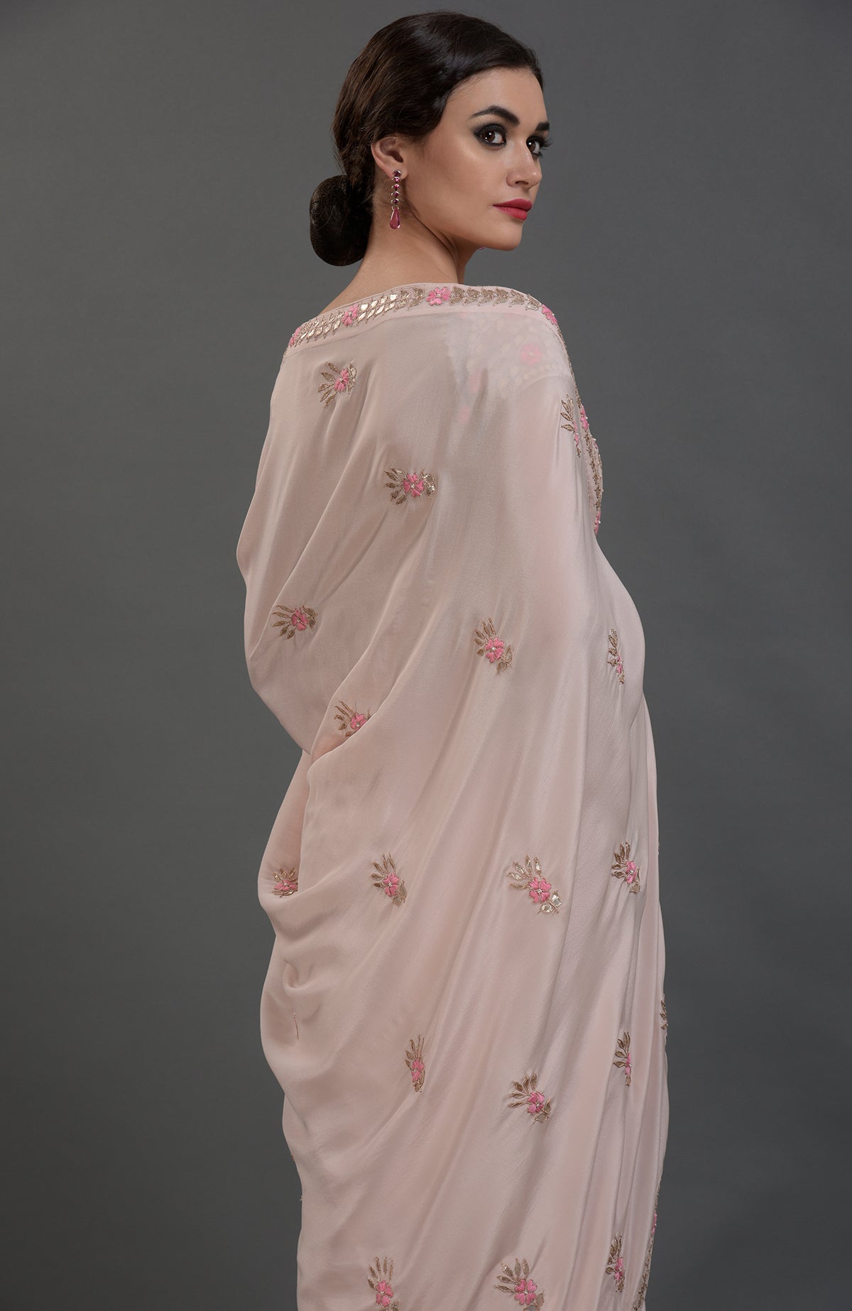 Nude pink pure crepe saree with rose gold gota patti and floral hand embroidery.
