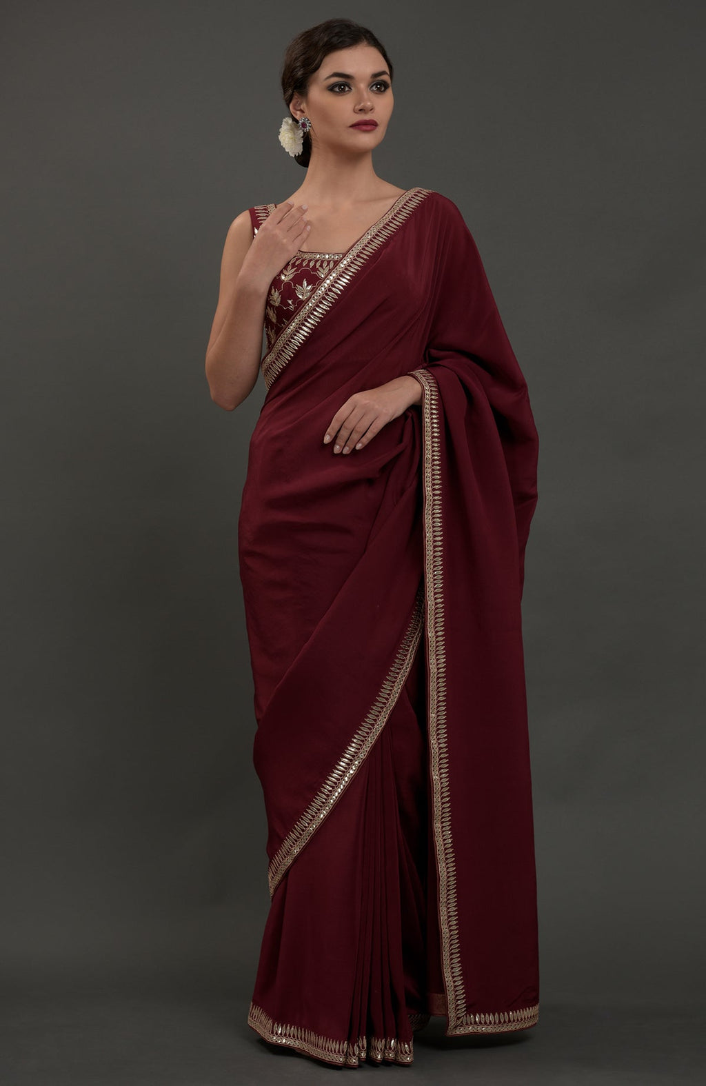 Burgundy crepe saree with silvery gold gota patti embroidery and matching blouse.