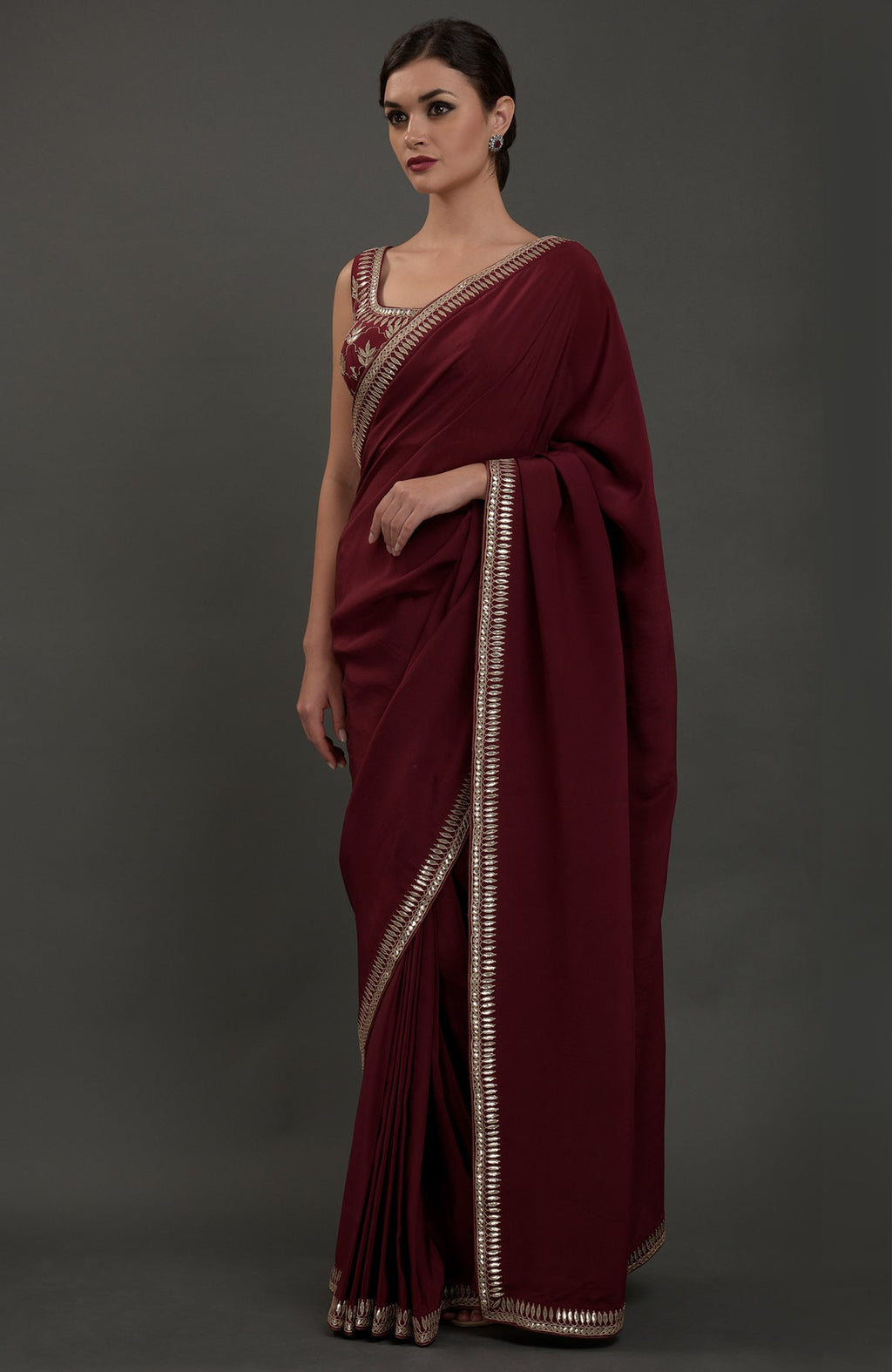 Burgundy crepe saree with silvery gold gota patti embroidery.